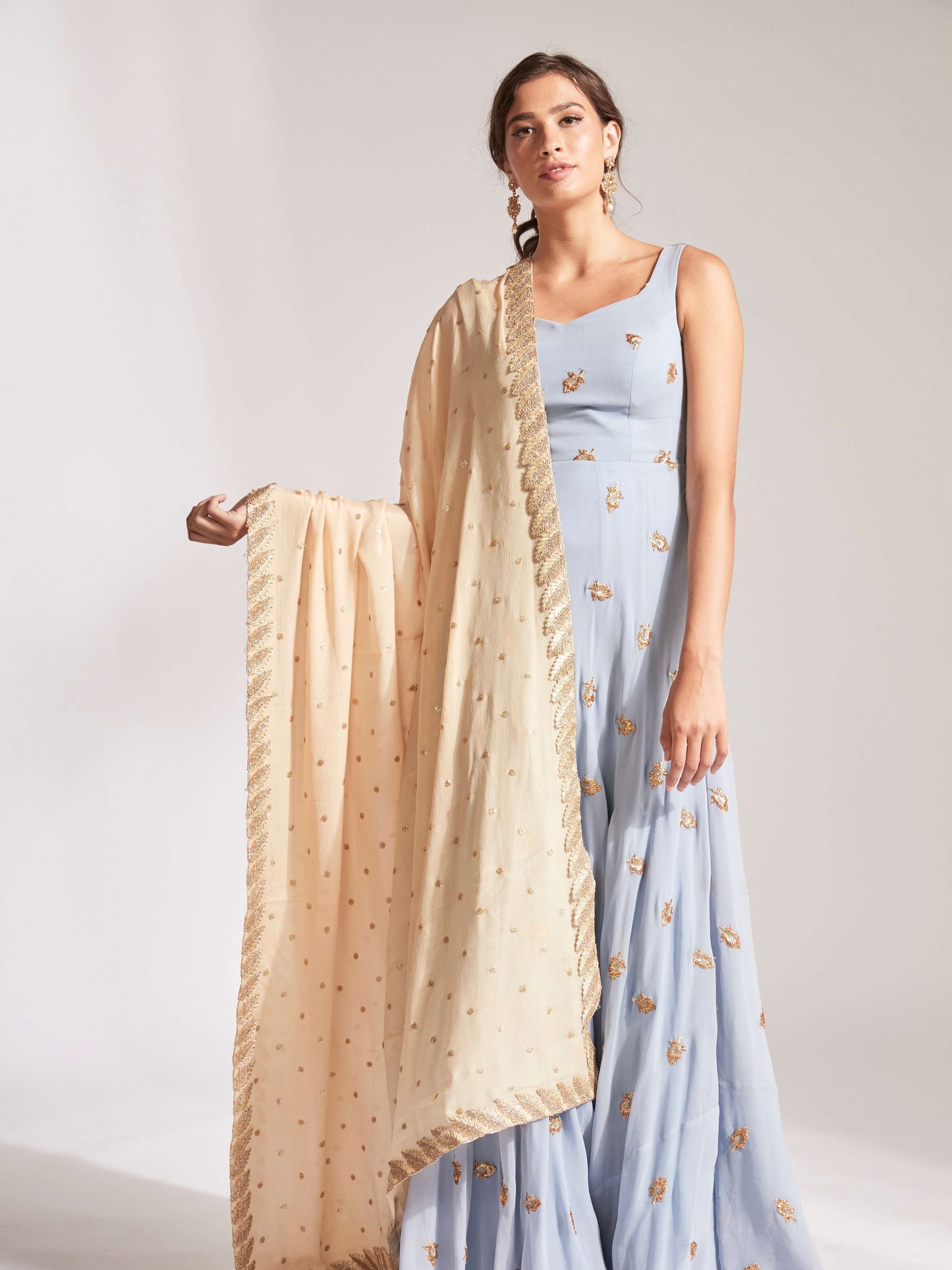 The Anita Anarkali is a dusty blue anarkali featuring a silk crepe dupatta in cream with booti work and border.