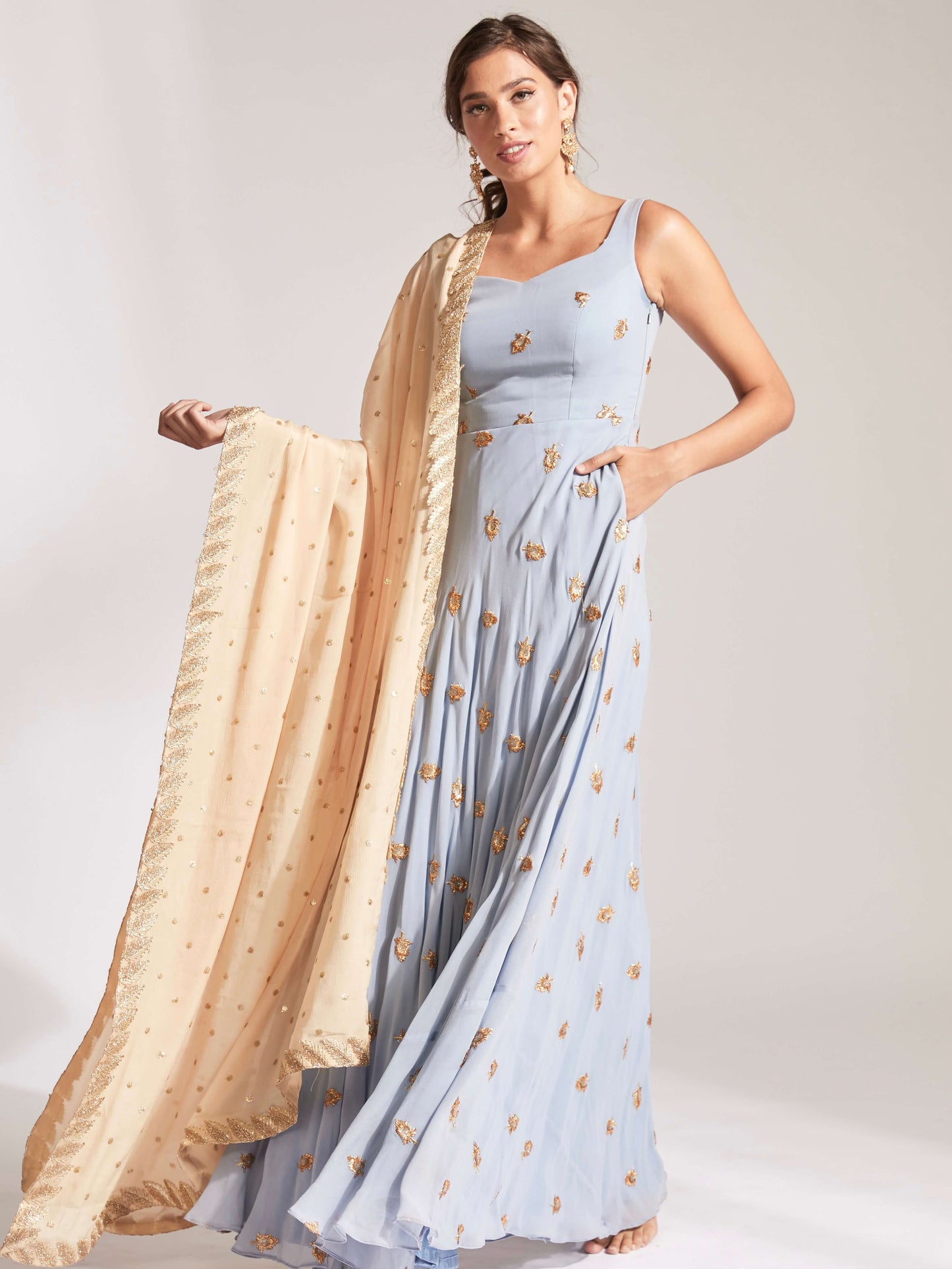 The Anita Anarkali is a dusty blue anarkali featuring a silk crepe dupatta in cream with booti work and border.