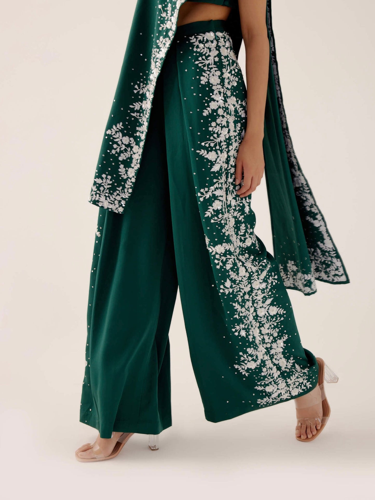 The Cleo Set consists of one shoulder top with hand-embroidered, high-waisted pants, and a detachable drape.