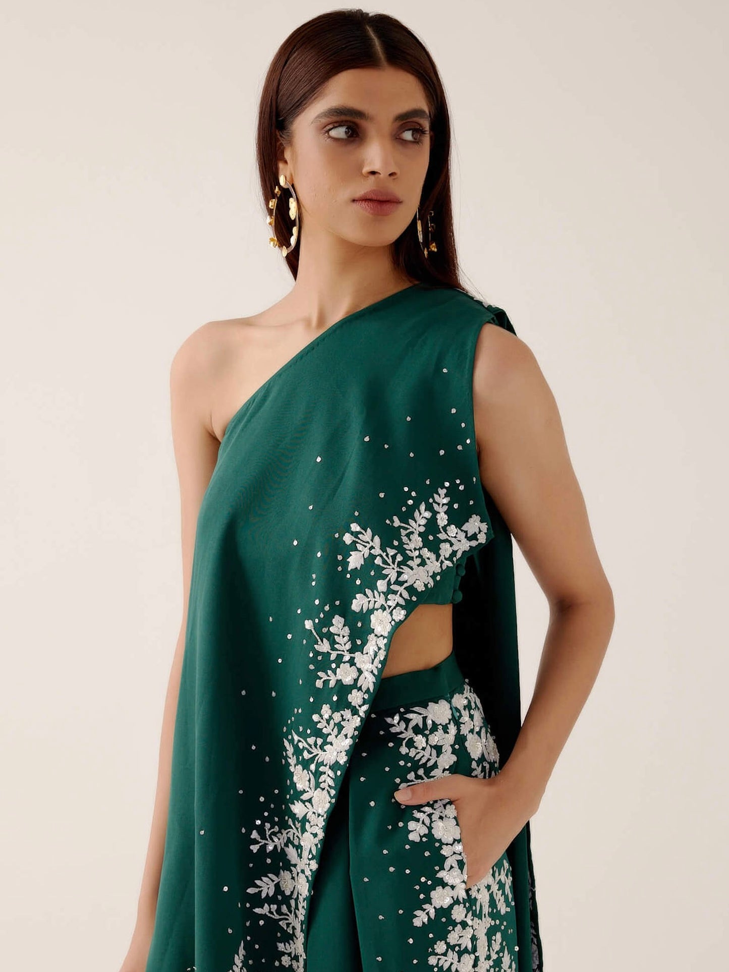 The Cleo Set consists of one shoulder top with hand-embroidered, high-waisted pants, and a detachable drape.