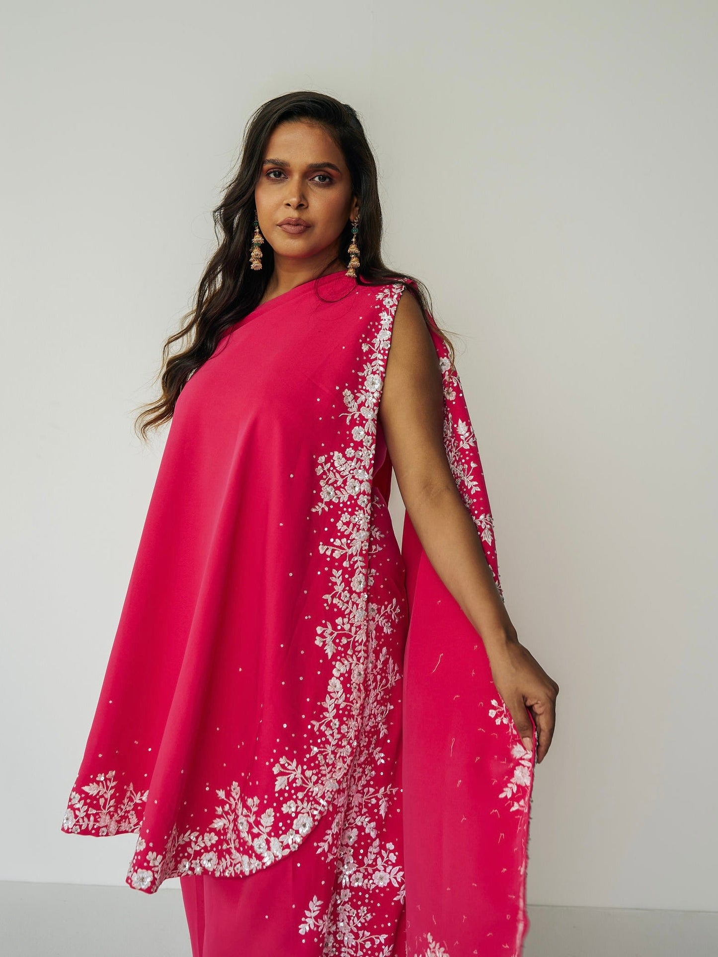 The Cleo Set consists of one shoulder top with hand-embroidered, high-waisted pants, and a detachable drape.