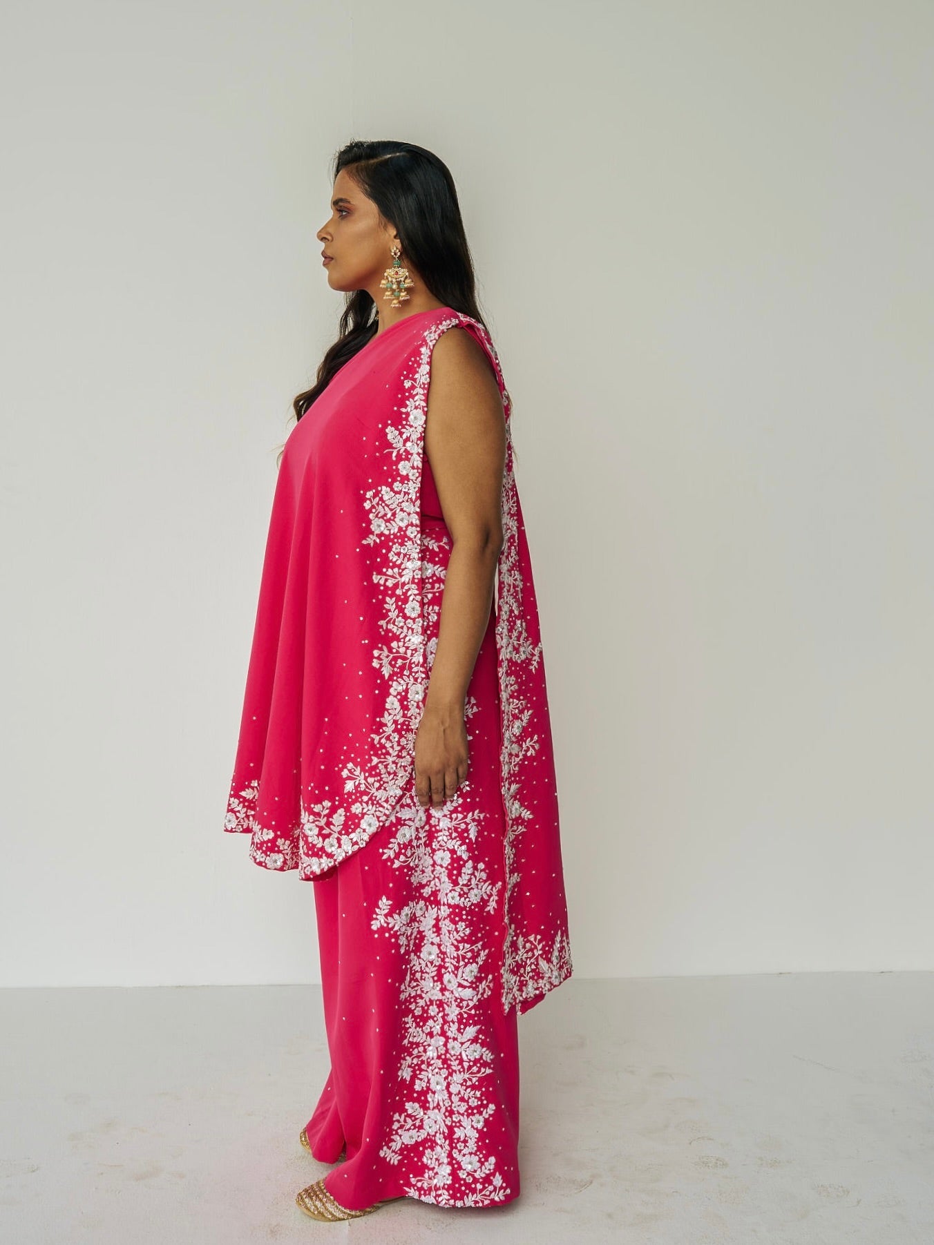 The Cleo Set consists of one shoulder top with hand-embroidered, high-waisted pants, and a detachable drape.