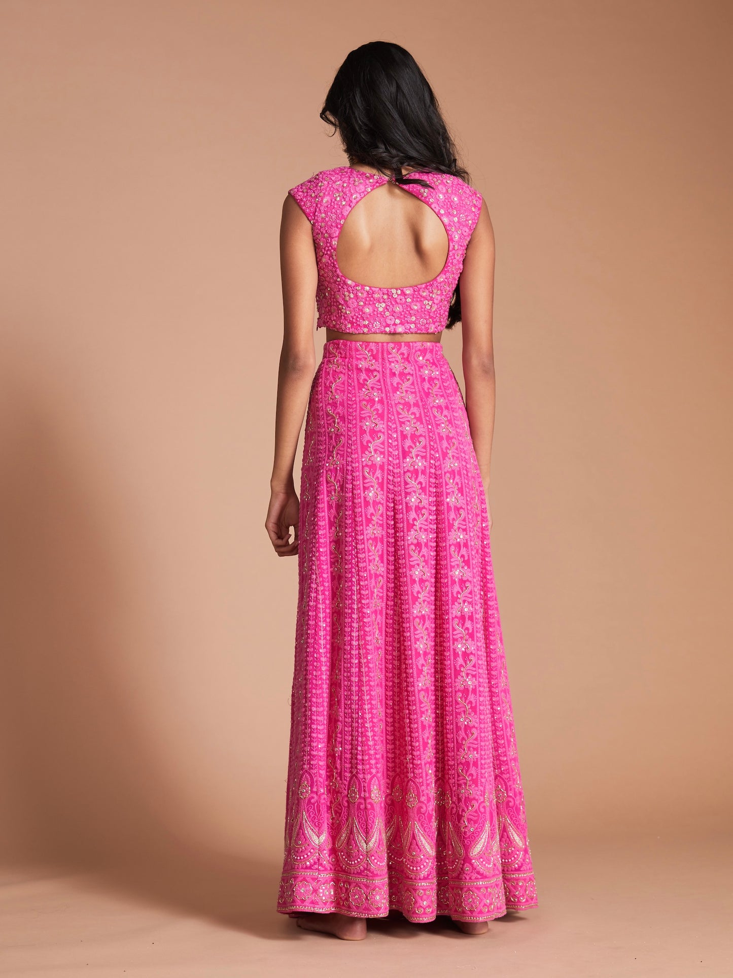 The Ishita Lehenga is a bright pink lucknowi (also known as chikankari) georgette skirt, a matching cap sleeve blouse and is paired with an off-white georgette dupatta.