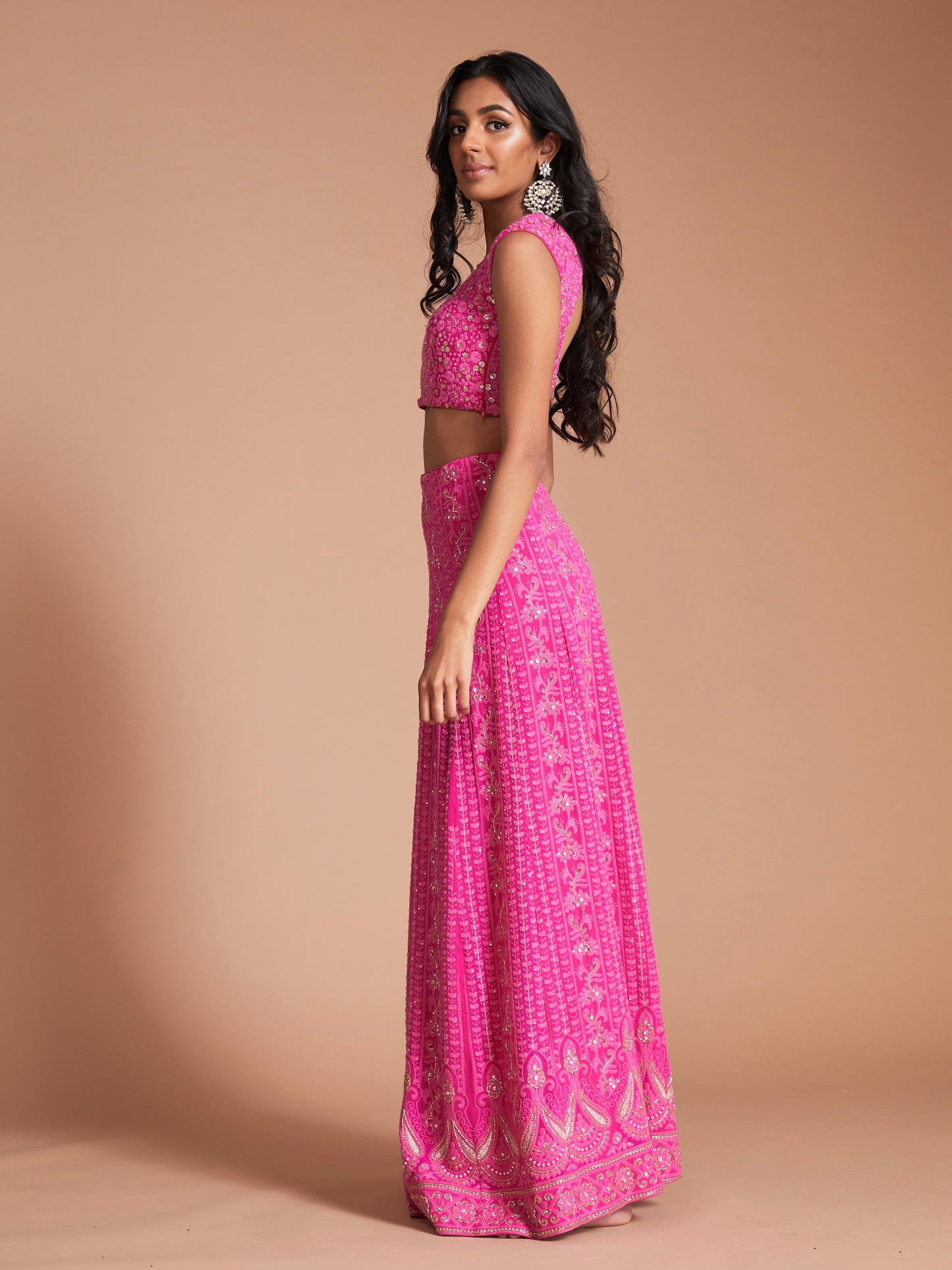 The Ishita Lehenga is a bright pink lucknowi (also known as chikankari) georgette skirt, a matching cap sleeve blouse and is paired with an off-white georgette dupatta.