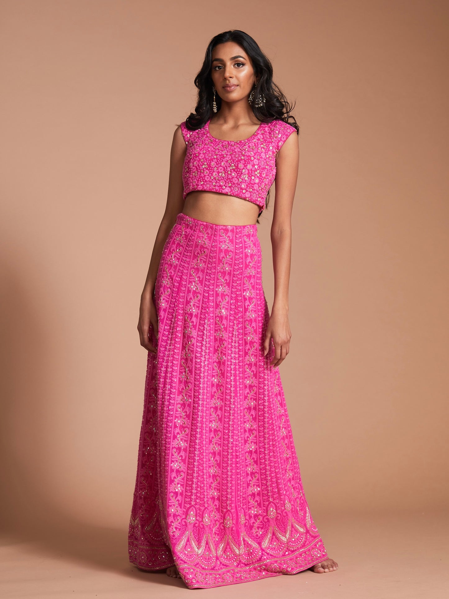 The Ishita Lehenga is a bright pink lucknowi (also known as chikankari) georgette skirt, a matching cap sleeve blouse and is paired with an off-white georgette dupatta.