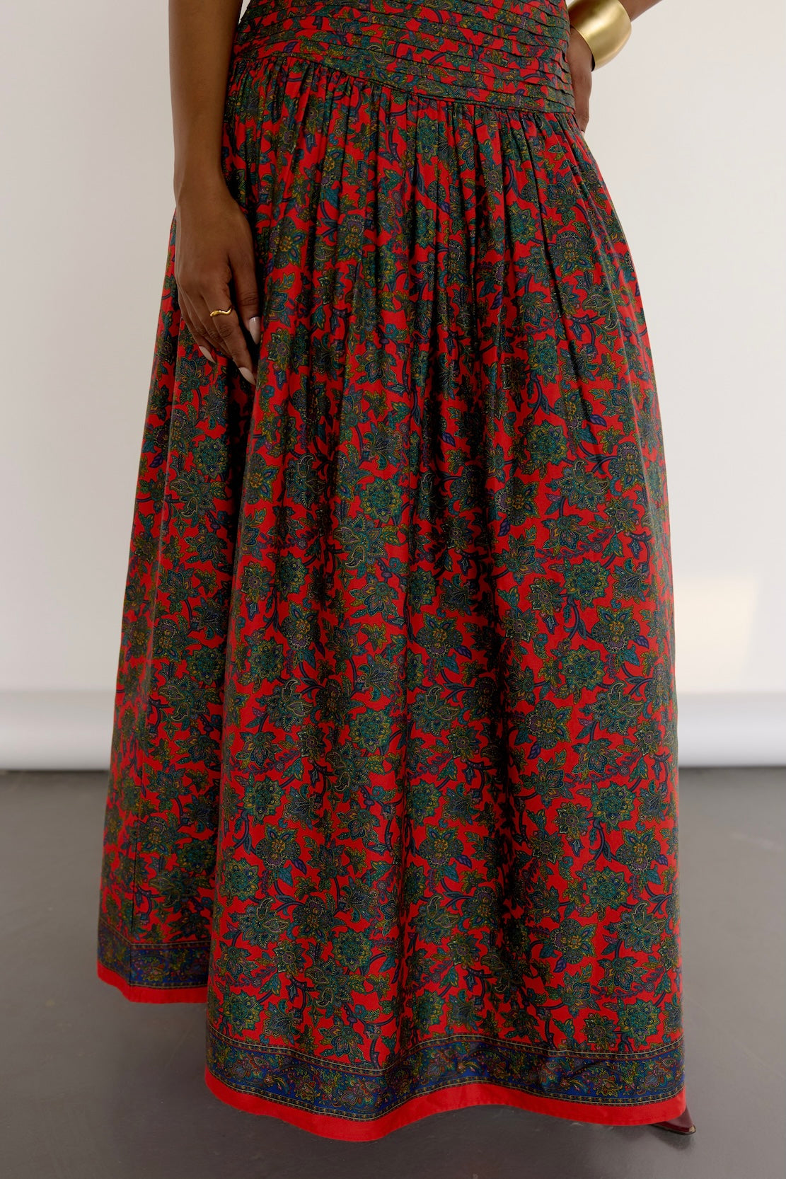 The Maya Dress features a vintage-inspired floral print. It’s strapless with a drop waist, a pleated bodice, and a softly gathered skirt. Choose the beaded version for extra shimmer with hand-done embroidery that follows the floral pattern, or go for the non-beaded if you’re feeling a little more laid-back.
