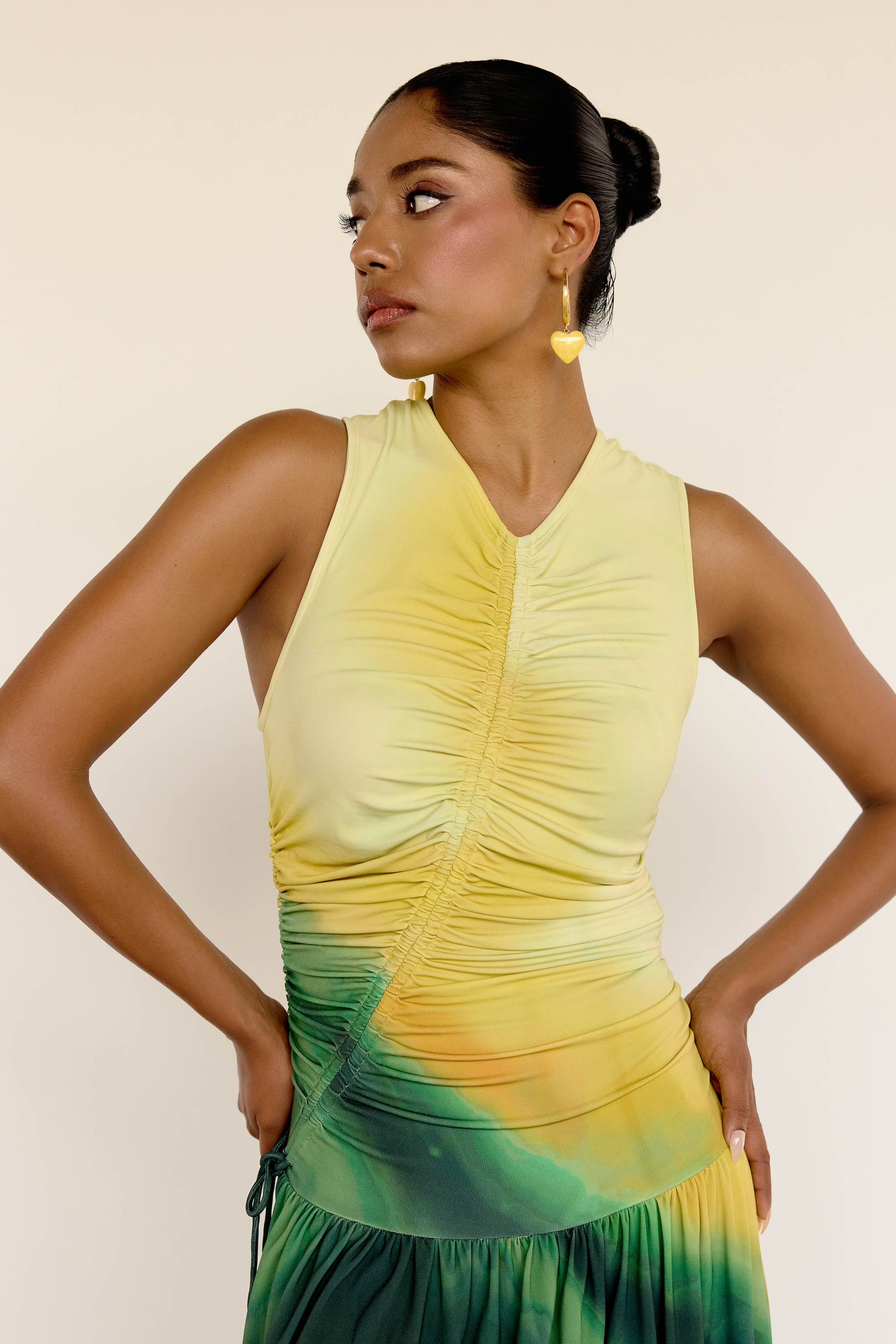 The Ruchi Dress is designed with versatility in mind, featuring a comfortable stretch fabric and an adjustable cinched waist for a customizable fit. The ombré color makes it easy to dress up or down for any occasion.