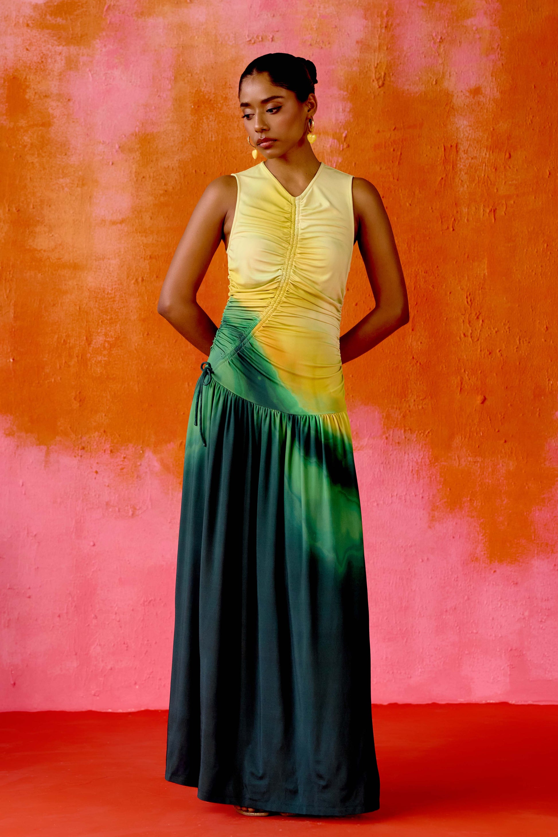 The Ruchi Dress is designed with versatility in mind, featuring a comfortable stretch fabric and an adjustable cinched waist for a customizable fit. The ombré color makes it easy to dress up or down for any occasion.