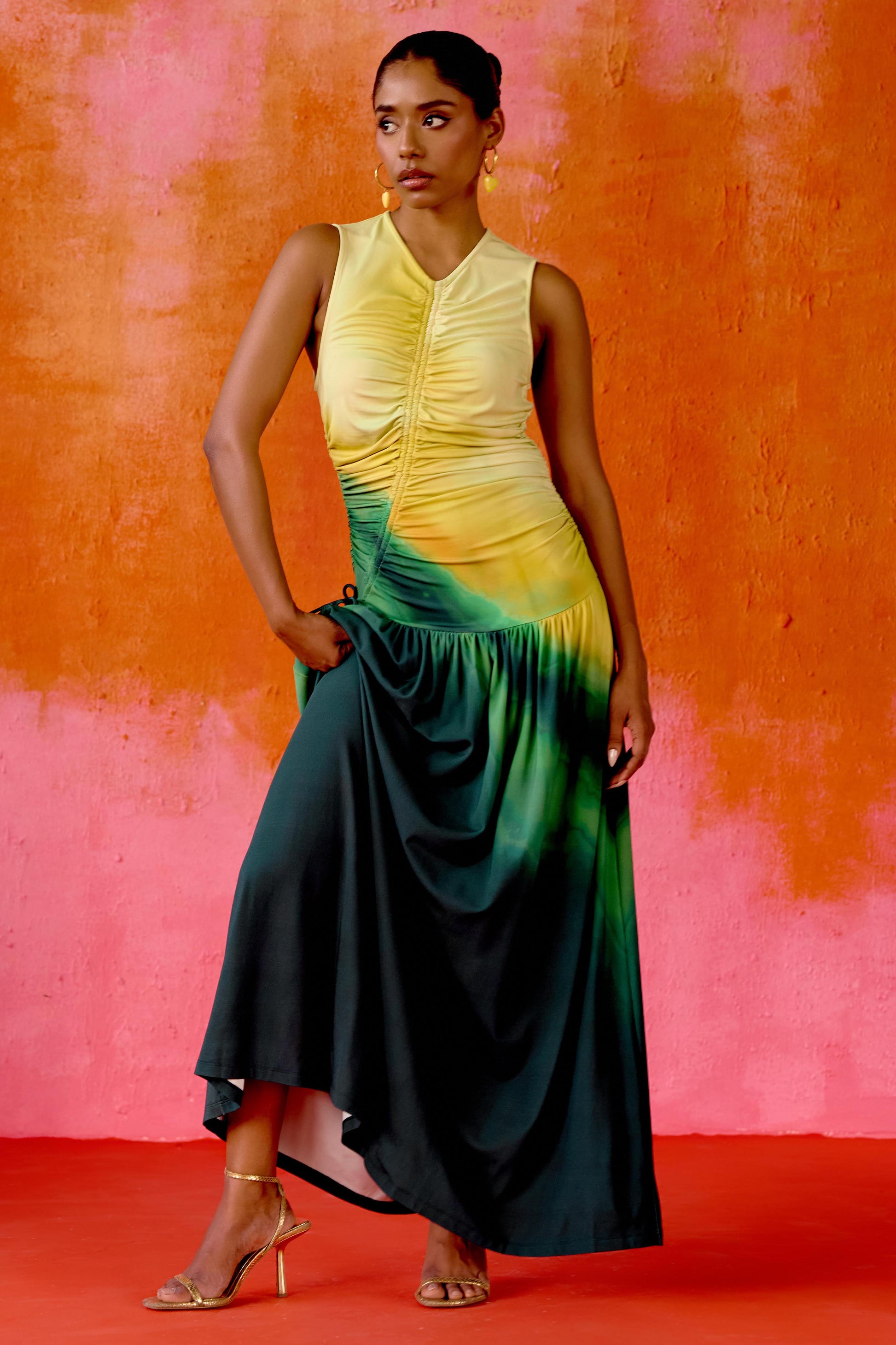 The Ruchi Dress is designed with versatility in mind, featuring a comfortable stretch fabric and an adjustable cinched waist for a customizable fit. The ombré color makes it easy to dress up or down for any occasion.