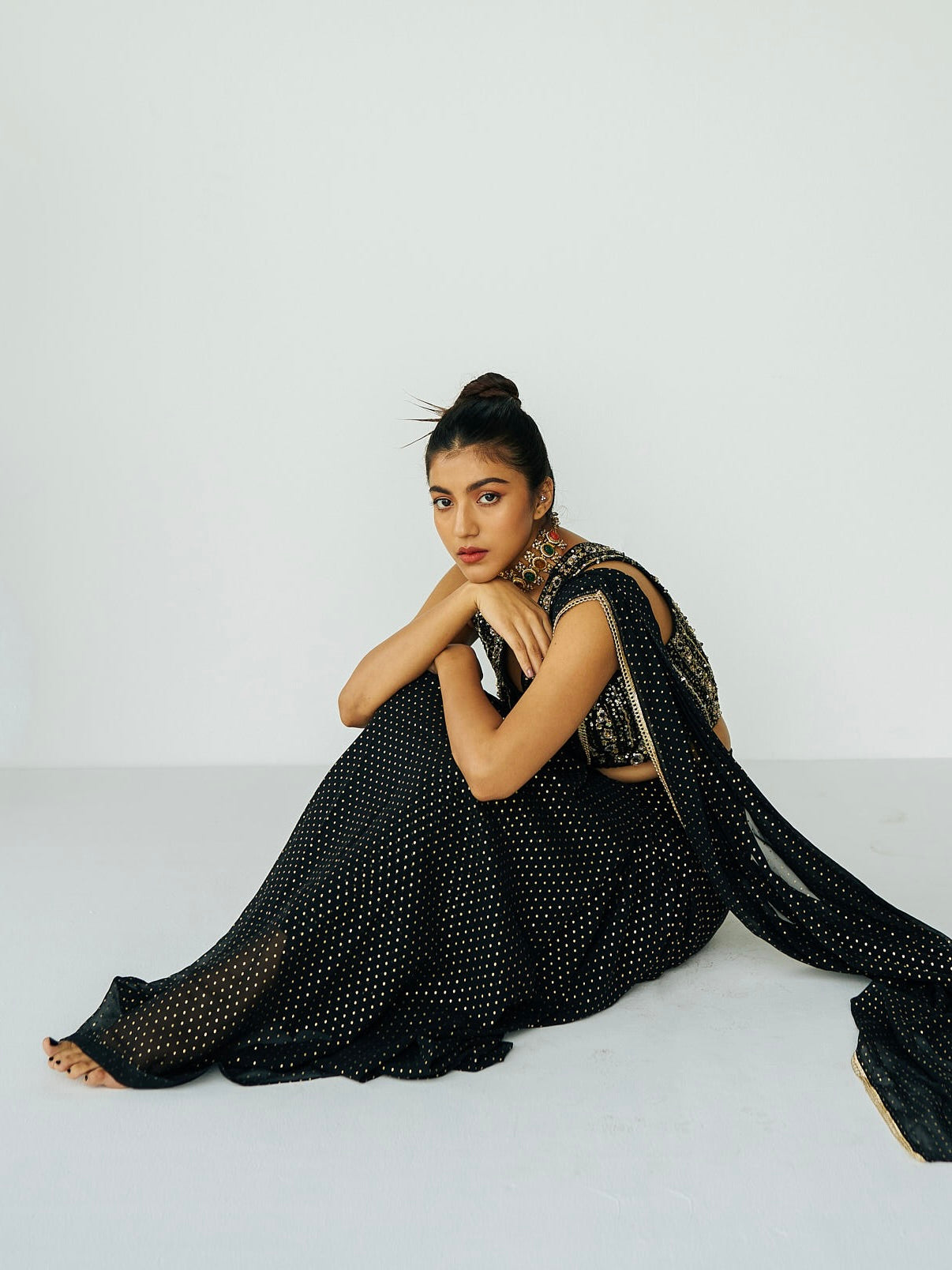 This outfit features a skirt with attached wrap-around draping - all pre-stitched so you can put the outfit together in 30 seconds or less. The drape has small gold embellishments throughout and the piece is paired with a gold hand-embroidered v-neck blouse.