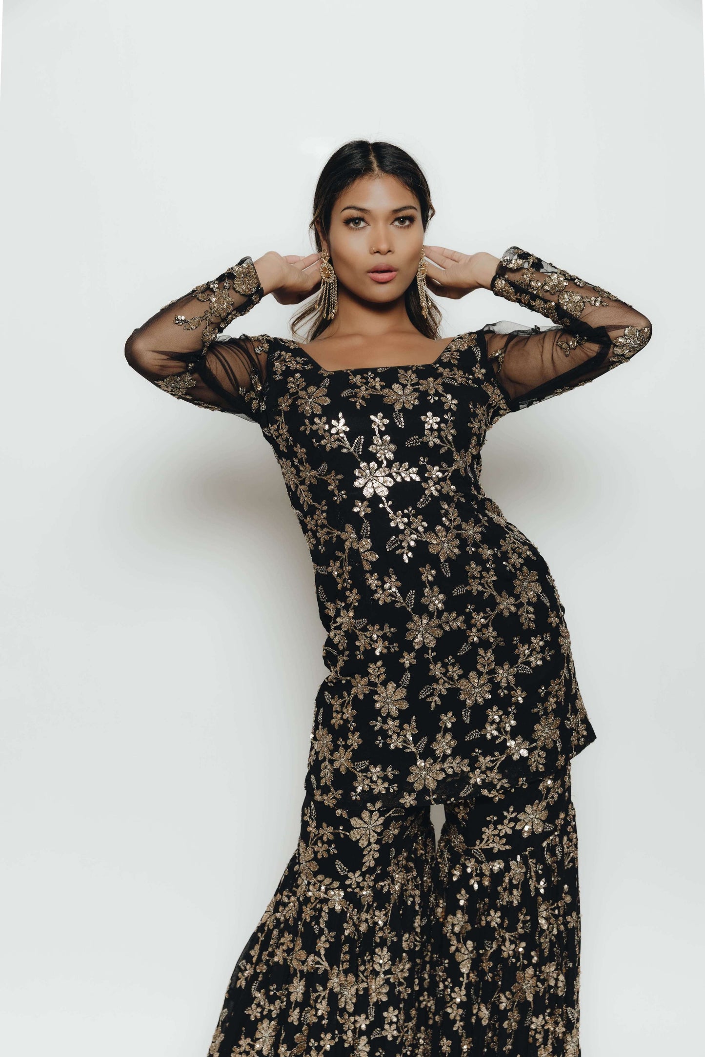 Woman in black and gold sequin outfit with Gharara pant, top, and dupatta