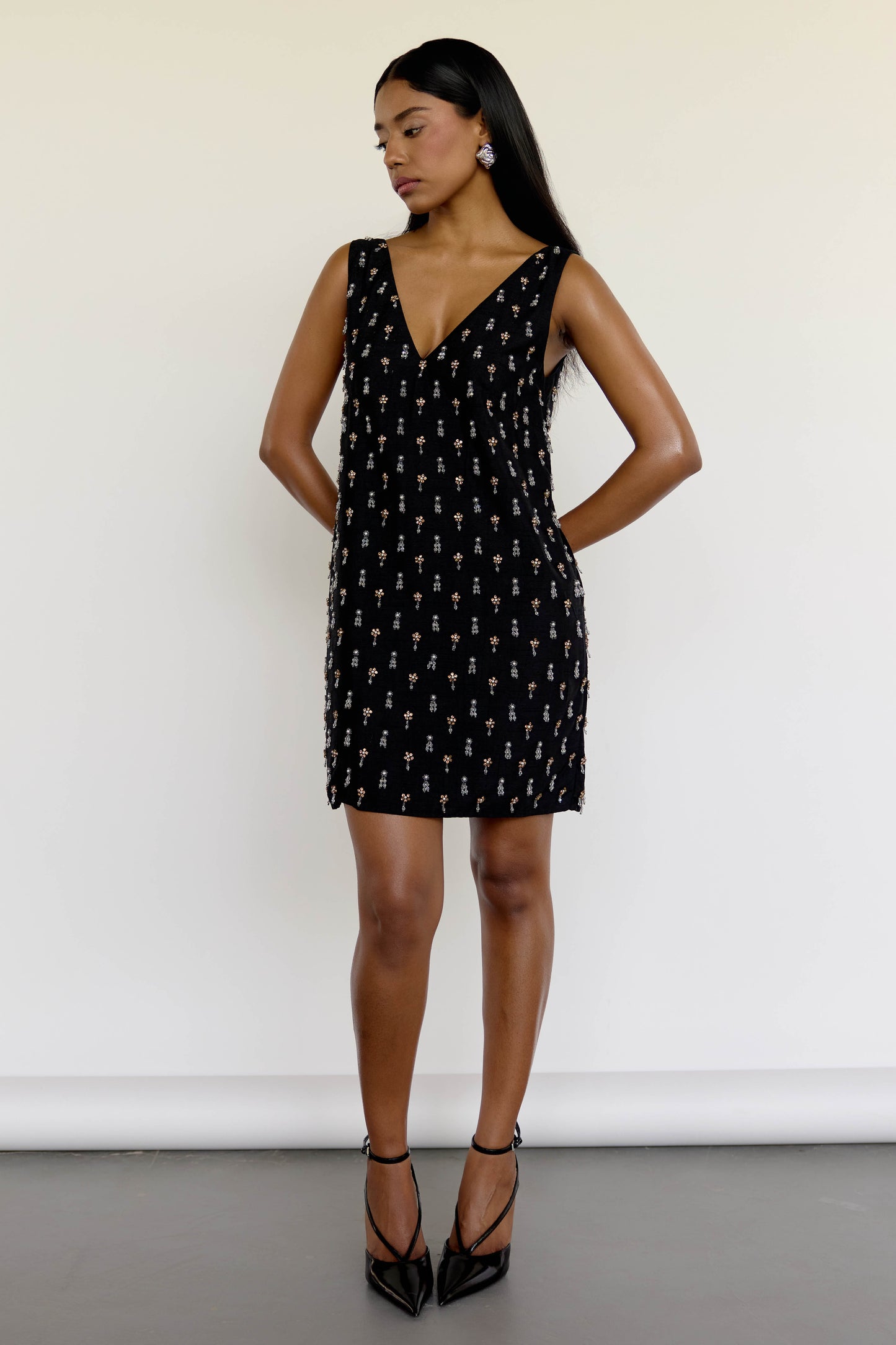 The Payal Dress is a standout piece for special occasions, featuring a shift-style mini dress silhouette adorned with hand-embroidered tassels throughout.