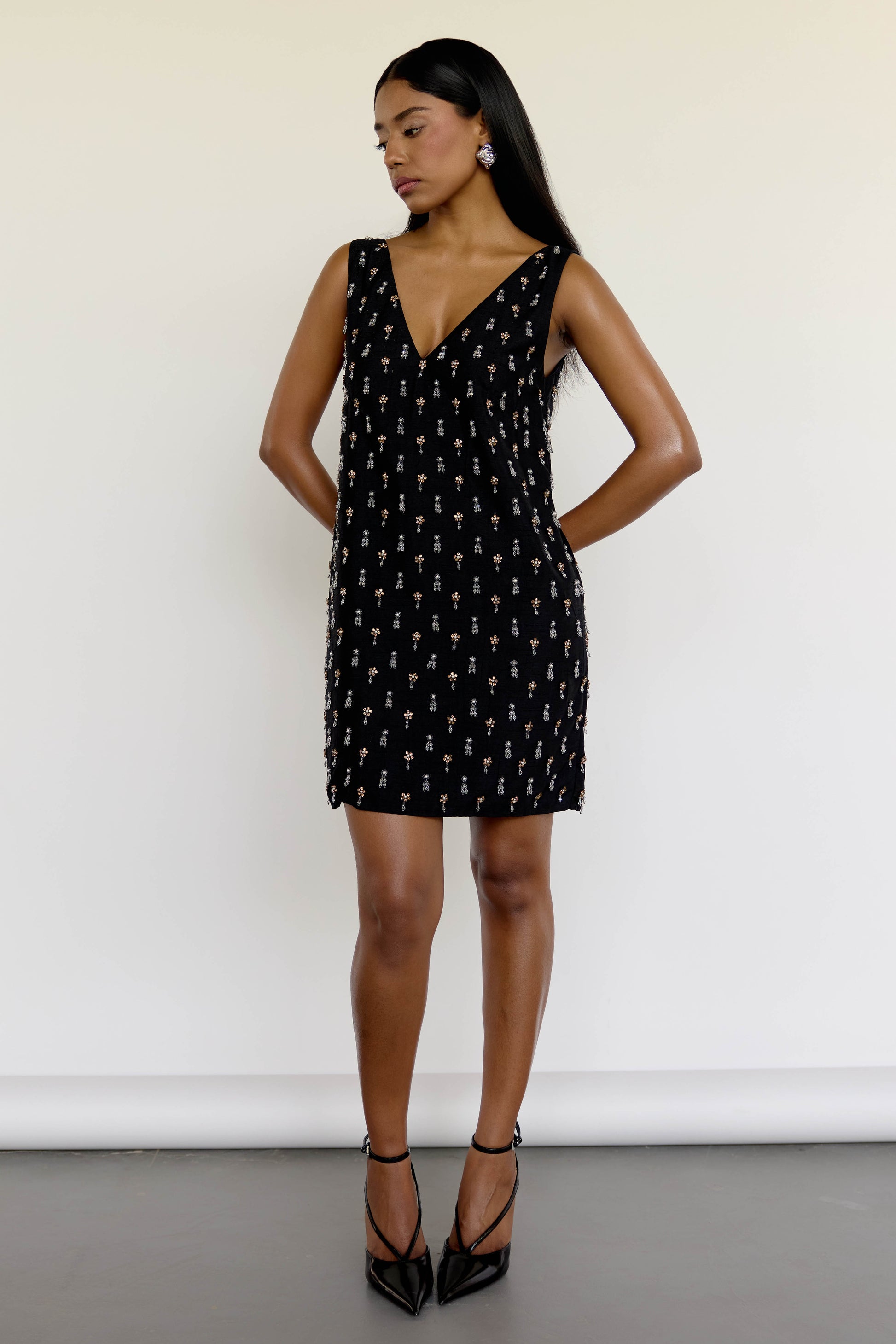 The Payal Dress is a standout piece for special occasions, featuring a shift-style mini dress silhouette adorned with hand-embroidered tassels throughout.