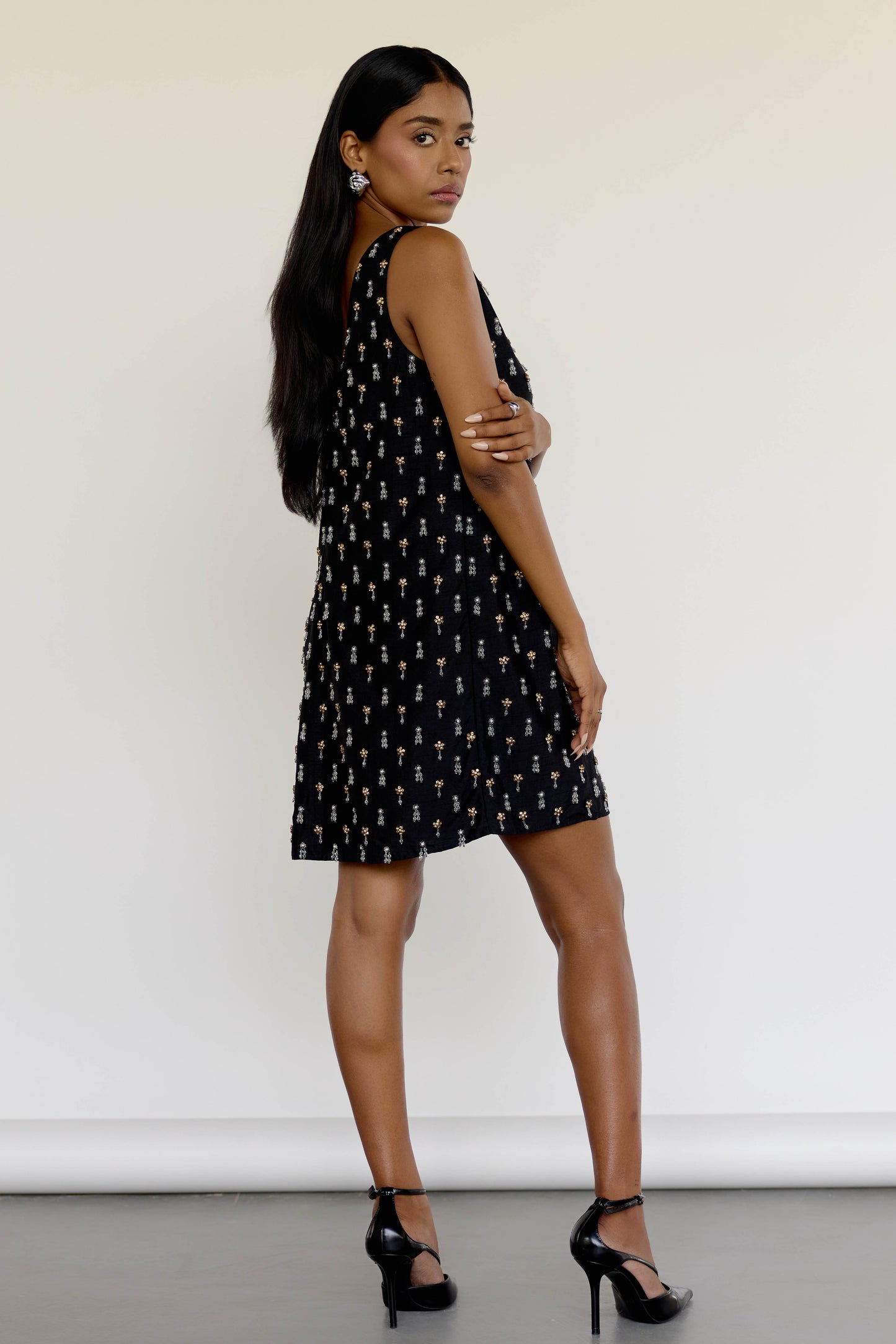 The Payal Dress is a standout piece for special occasions, featuring a shift-style mini dress silhouette adorned with hand-embroidered tassels throughout.