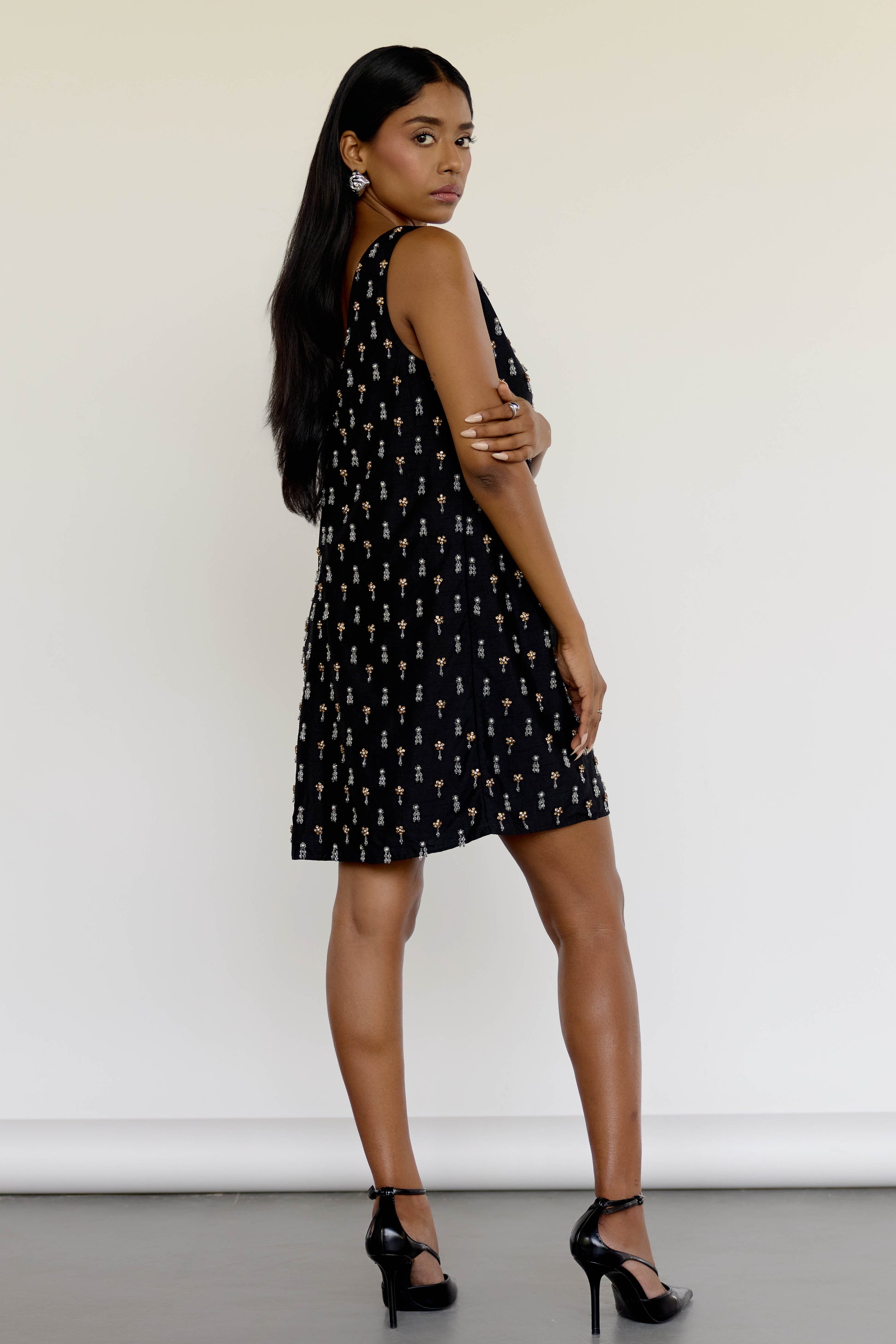 The Payal Dress is a standout piece for special occasions, featuring a shift-style mini dress silhouette adorned with hand-embroidered tassels throughout.
