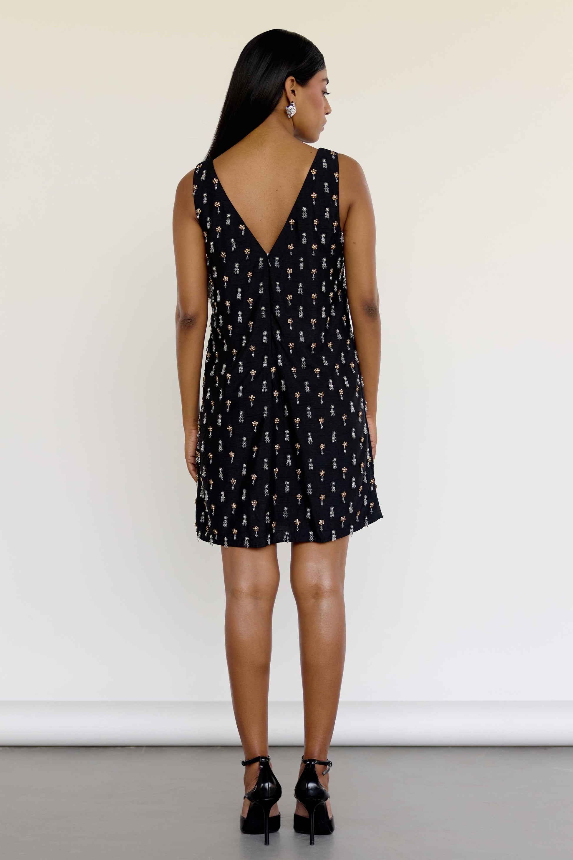 The Payal Dress is a standout piece for special occasions, featuring a shift-style mini dress silhouette adorned with hand-embroidered tassels throughout.