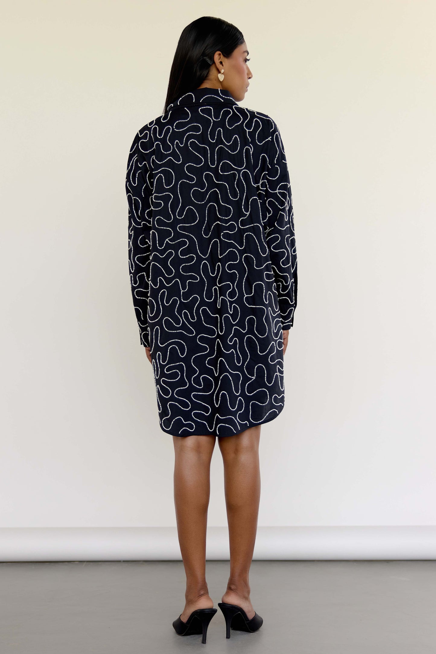 The Kira Dress is our twist on the classic shirt dress—tailored in silhouette but detailed with winding threadwork and subtle beading for just the right amount of drama. Made from soft 100% cotton and finished with contrast buttons, it's the kind of dress that works just as well with sneakers as it does with heels.