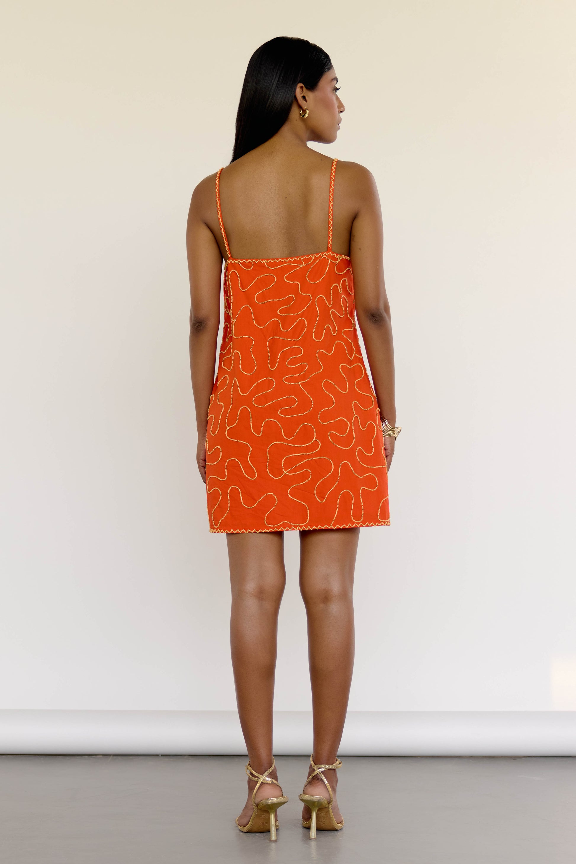 The Meera Dress is made from 100% cotton and features abstract, hand-beaded detailing that adds just the right amount of texture. With its vibrant orange hue and flattering mini silhouette, it’s an easy go-to for summer dinners, vacation nights, or whenever “subtle” just won’t cut it.