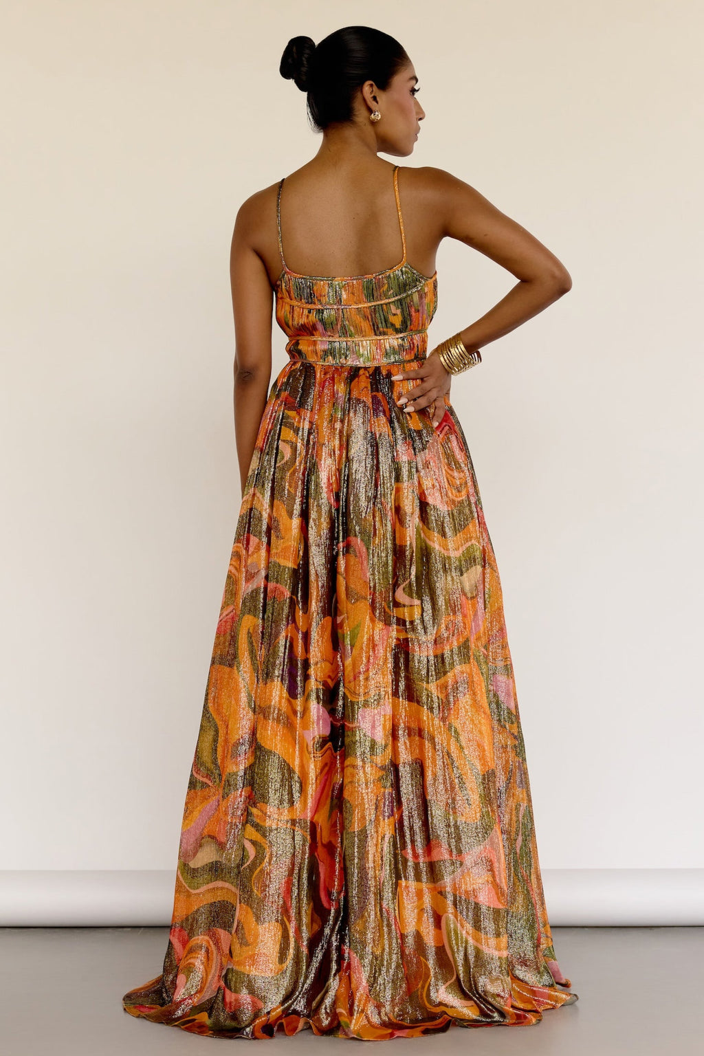 The Leela Dress features a subtle metallic print and a classic A-line silhouette. A fitted bodice gives way to a flowing skirt, creating a look that’s easy to wear and effortlessly polished.