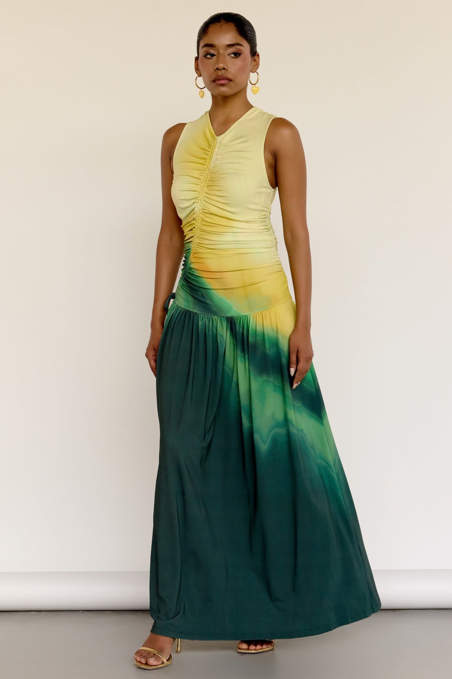 The Ruchi Dress is designed with versatility in mind, featuring a comfortable stretch fabric and an adjustable cinched waist for a customizable fit. The ombré color makes it easy to dress up or down for any occasion.