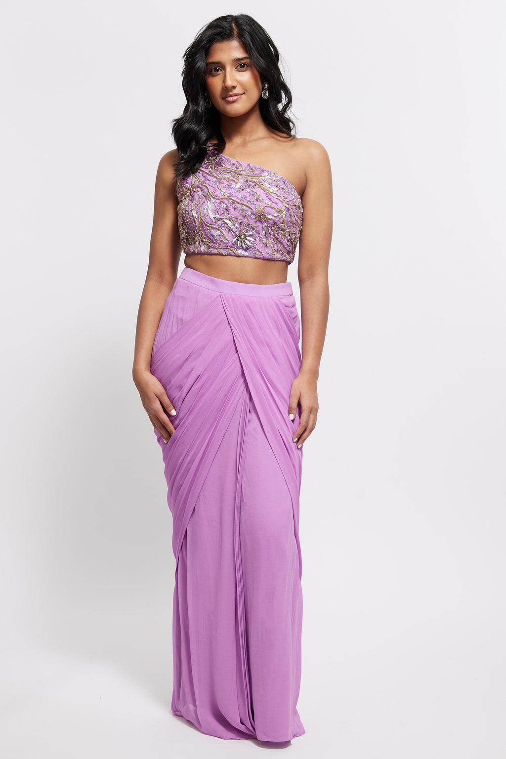 The Aria Ruffle Set features a hand embroidered one-shoulder blouse and pleated skirt that is paired back to a ruffled dupatta.
