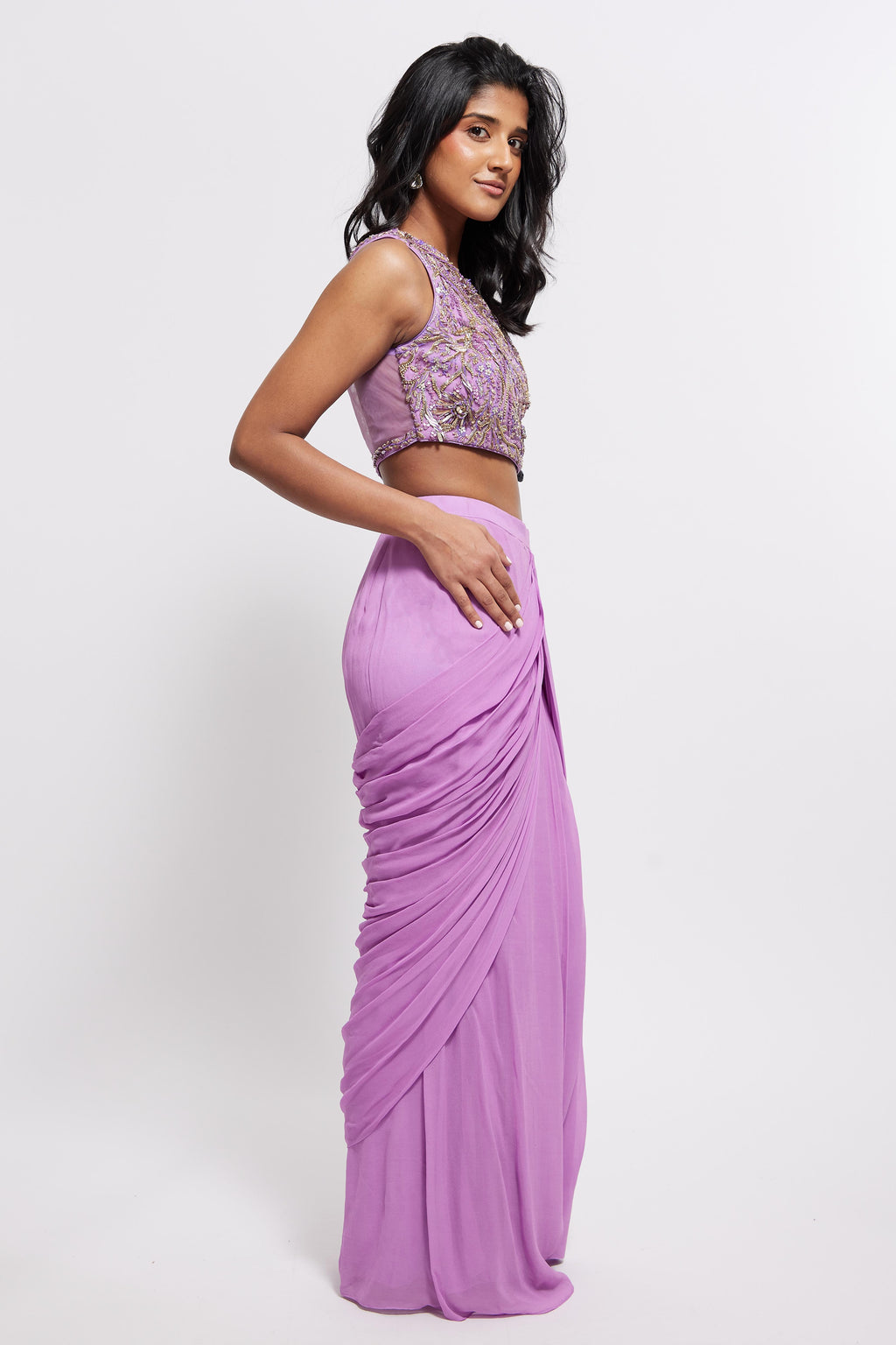 The Aria Ruffle Set features a hand embroidered one-shoulder blouse and pleated skirt that is paired back to a ruffled dupatta.