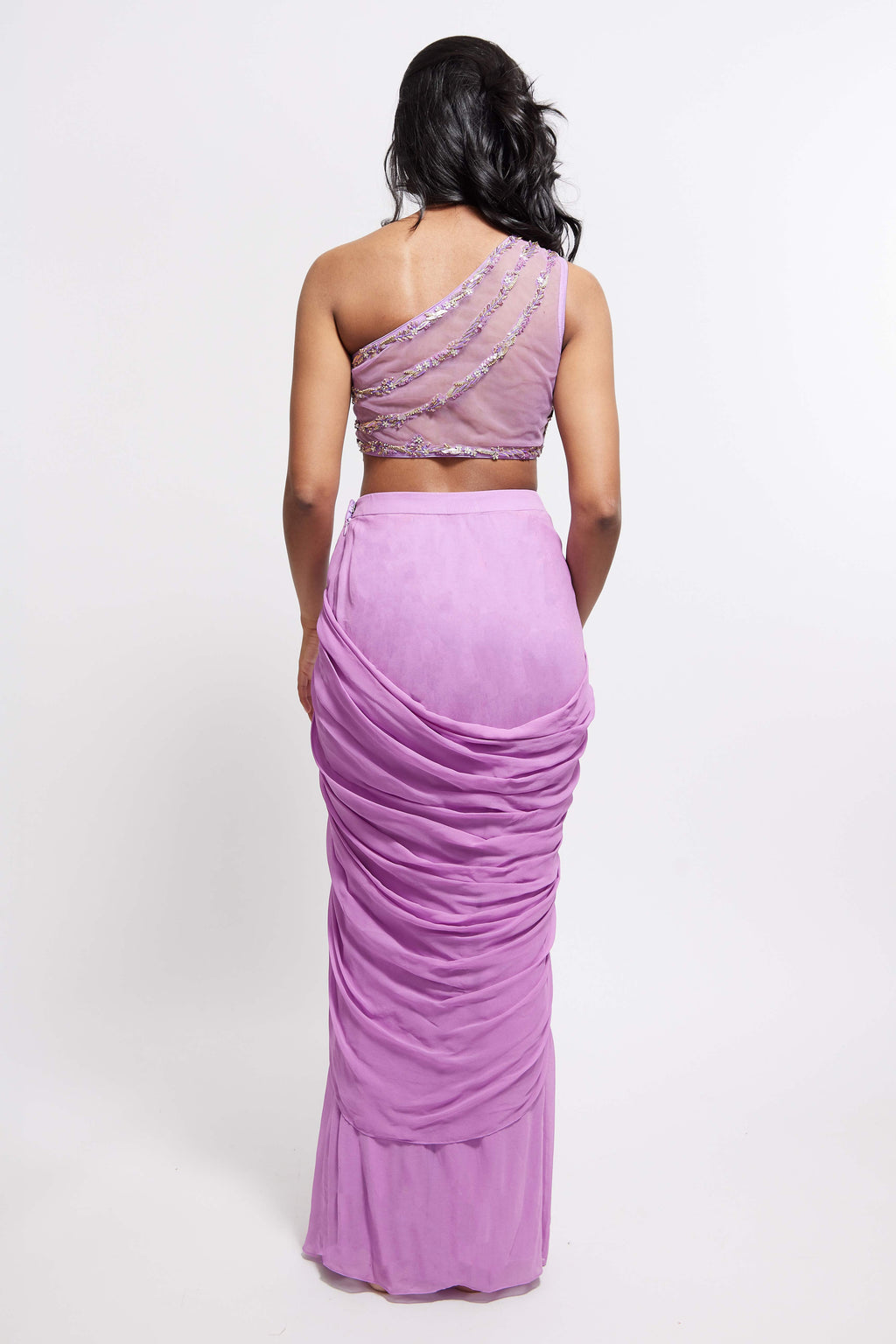 The Aria Ruffle Set features a hand embroidered one-shoulder blouse and pleated skirt that is paired back to a ruffled dupatta.