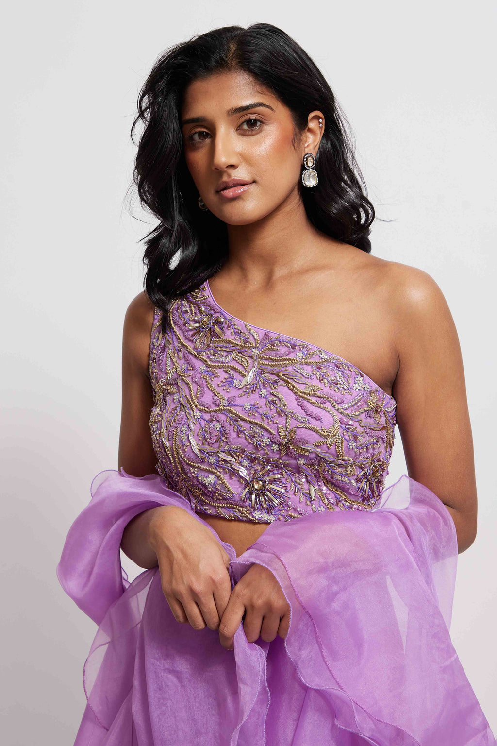 The Aria Ruffle Set features a hand embroidered one-shoulder blouse and pleated skirt that is paired back to a ruffled dupatta.