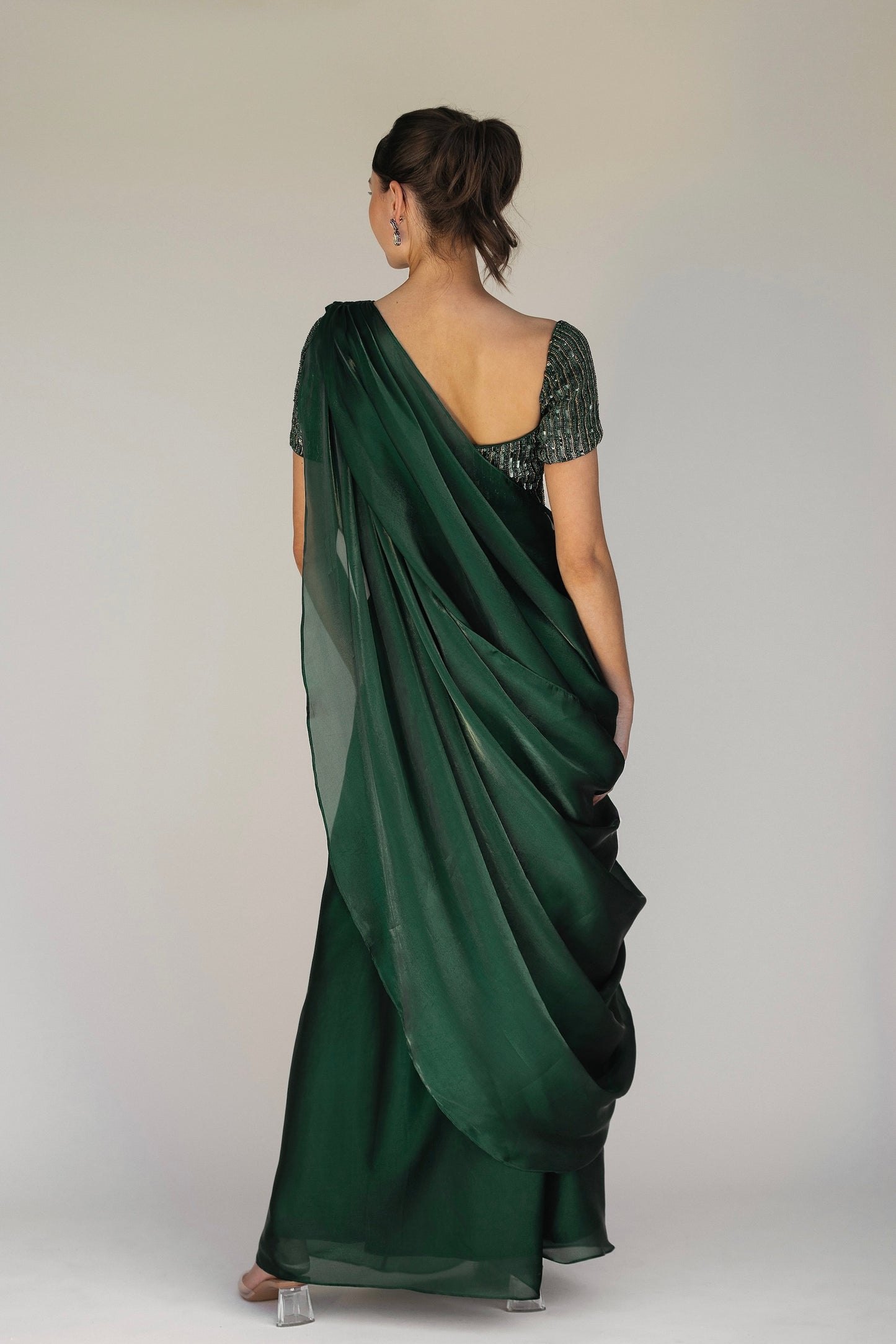 The Adya Drape Saree makes it easy to get the saree look without any pleating and features a shiny organaza skirt with an attached drape + a hand embroidered, bustier top.