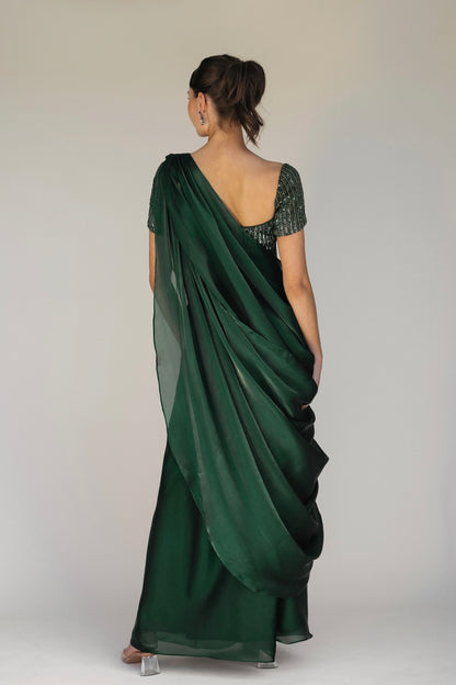 The Adya Drape Saree makes it easy to get the saree look without any pleating and features a shiny organaza skirt with an attached drape + a hand embroidered, bustier top.