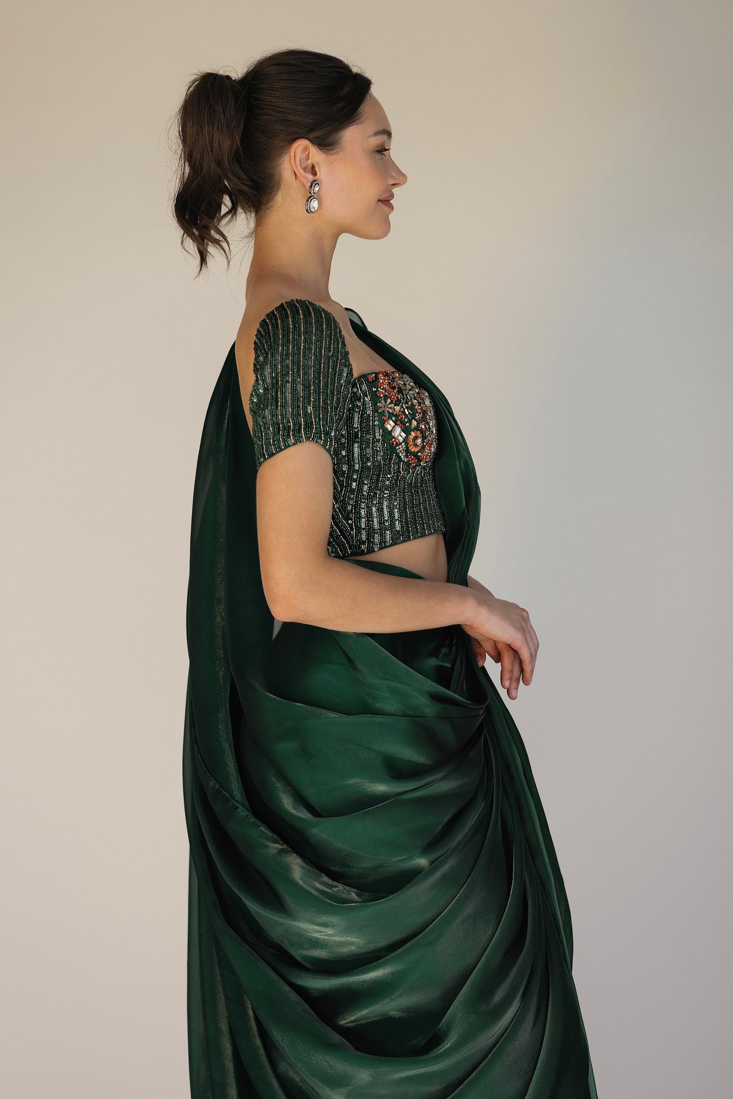 The Adya Drape Saree makes it easy to get the saree look without any pleating and features a shiny organaza skirt with an attached drape + a hand embroidered, bustier top.