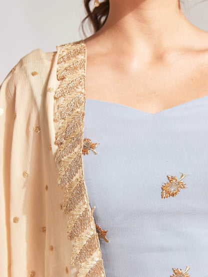 The Anita Anarkali is a dusty blue anarkali featuring a silk crepe dupatta in cream with booti work and border.
