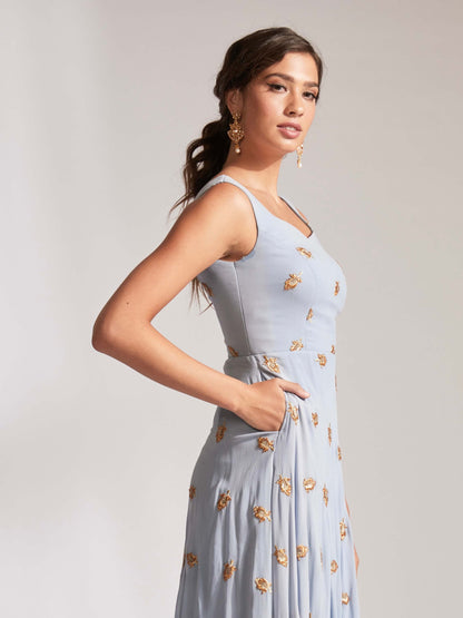 The Anita Anarkali is a dusty blue anarkali featuring a silk crepe dupatta in cream with booti work and border.