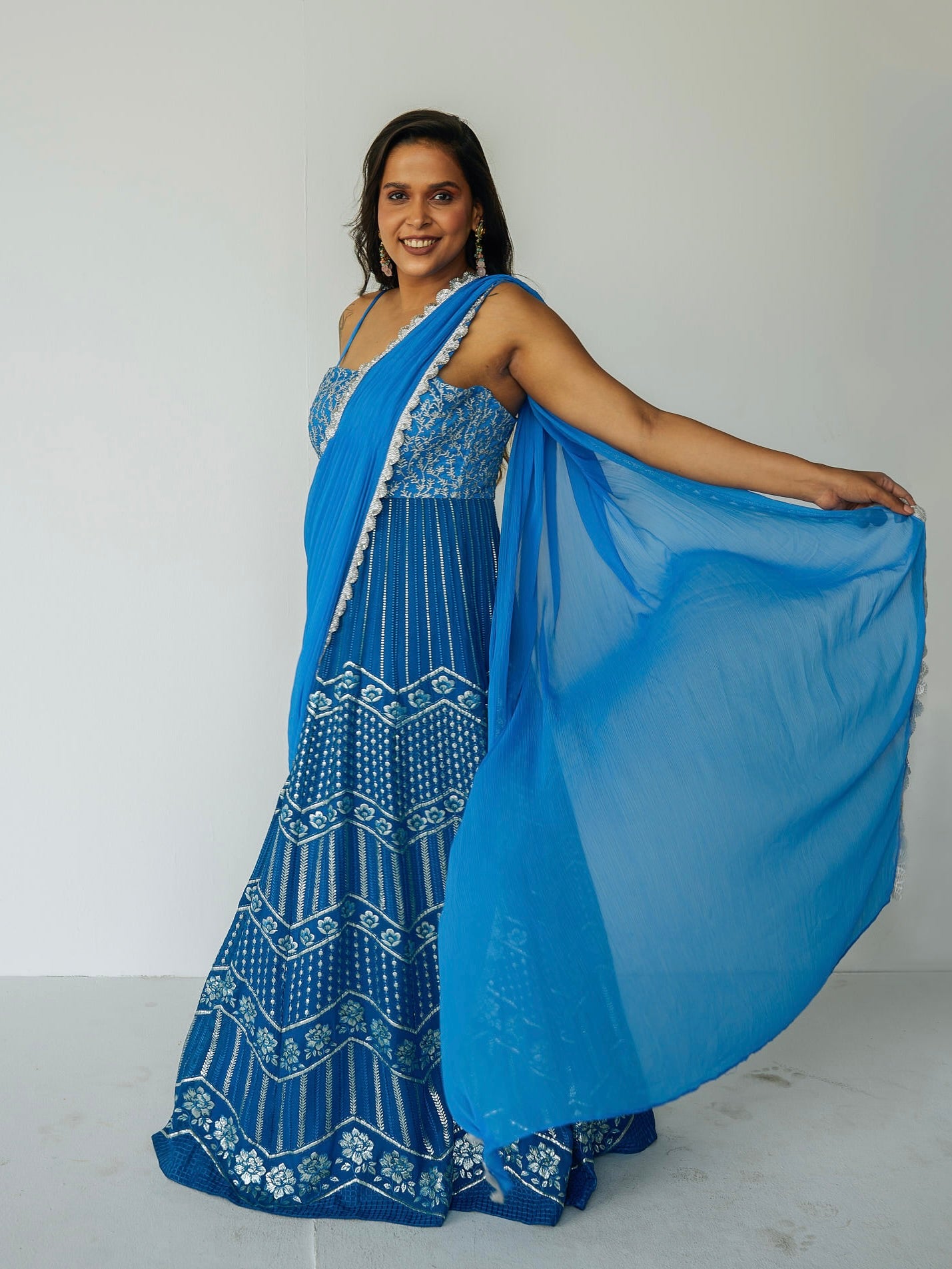 The Anjali Anarkali in cobalt features metallic layered embroidery and is paired with an attached dupatta (so you can't lose or trip on it).