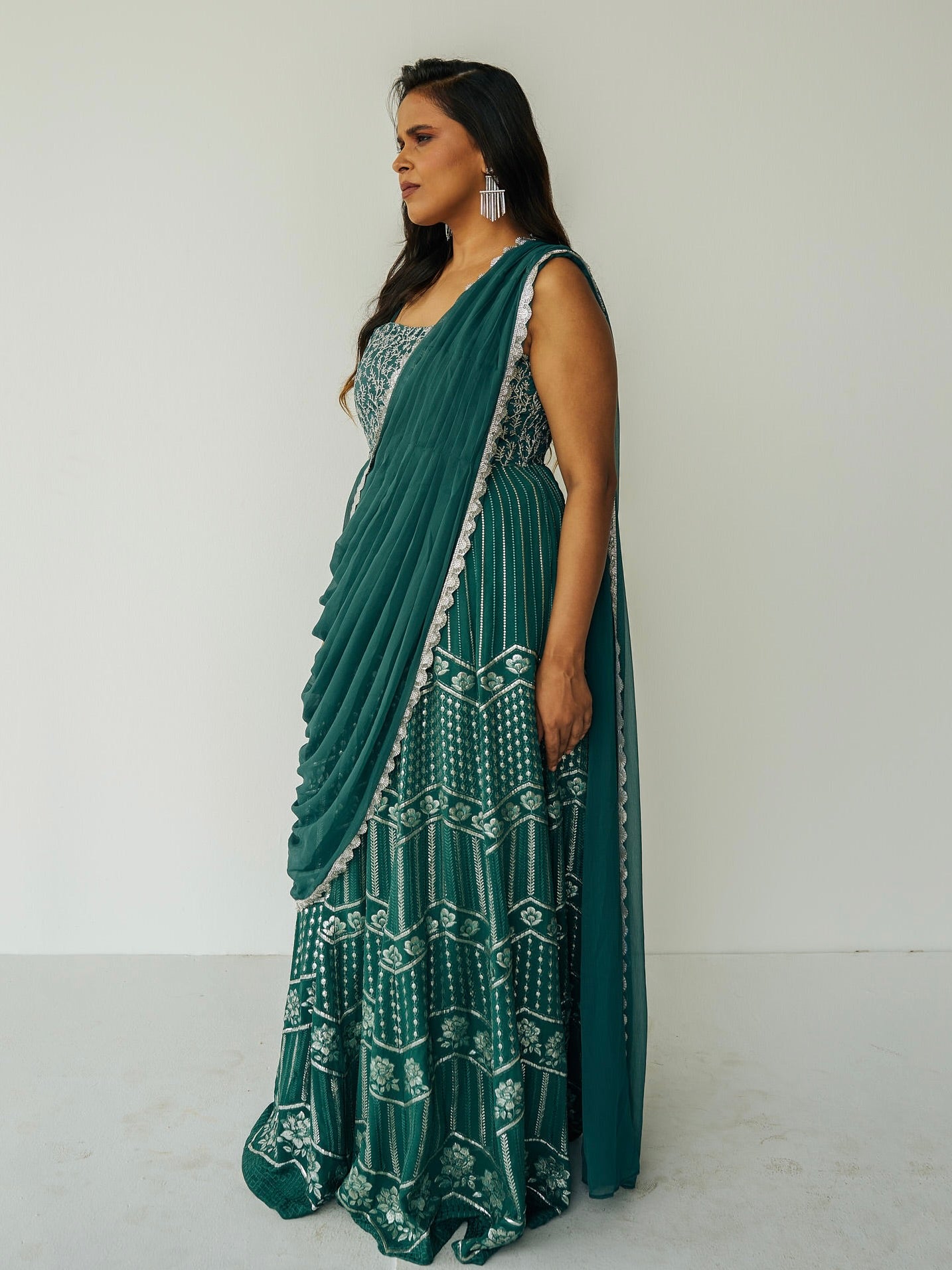 The Anjali Anarkali in green features metallic layered embroidery and is paired with an attached dupatta (so you can't lose or trip on it).