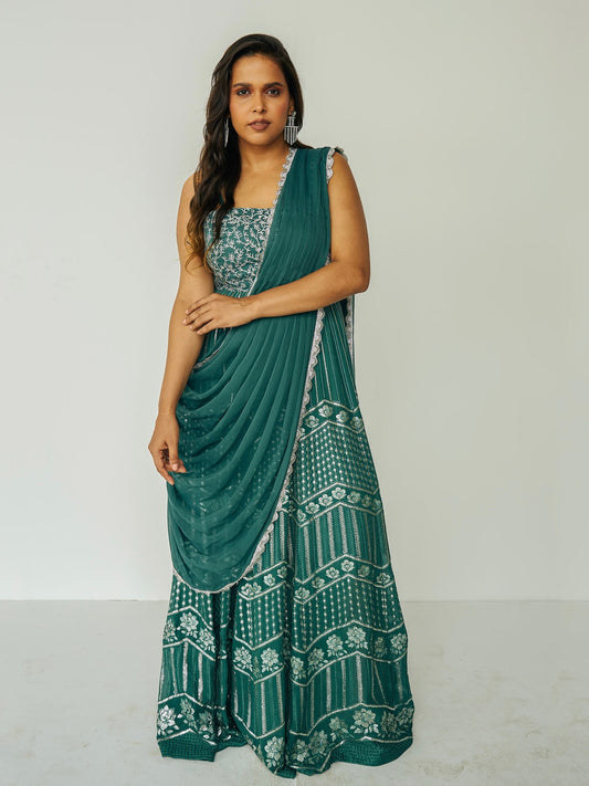 The Anjali Anarkali in green features metallic layered embroidery and is paired with an attached dupatta (so you can't lose or trip on it).