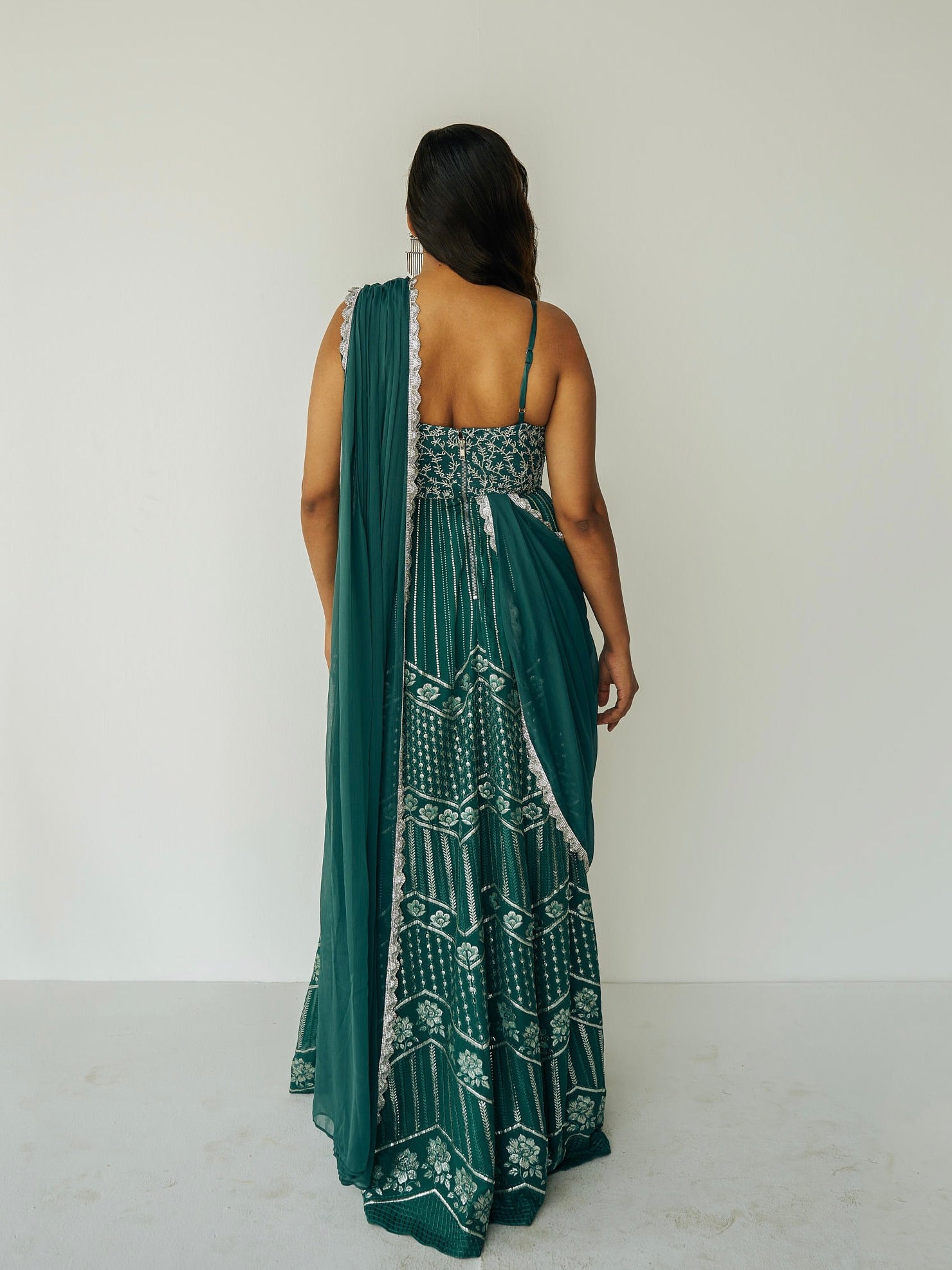 The Anjali Anarkali in green features metallic layered embroidery and is paired with an attached dupatta (so you can't lose or trip on it).