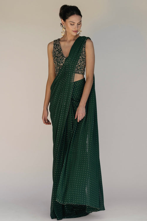 This saree has a hand-embroidered cropped top with intricate beadwork and lustrous sequins and is paired with a skirt featuring attached wraparound draping.