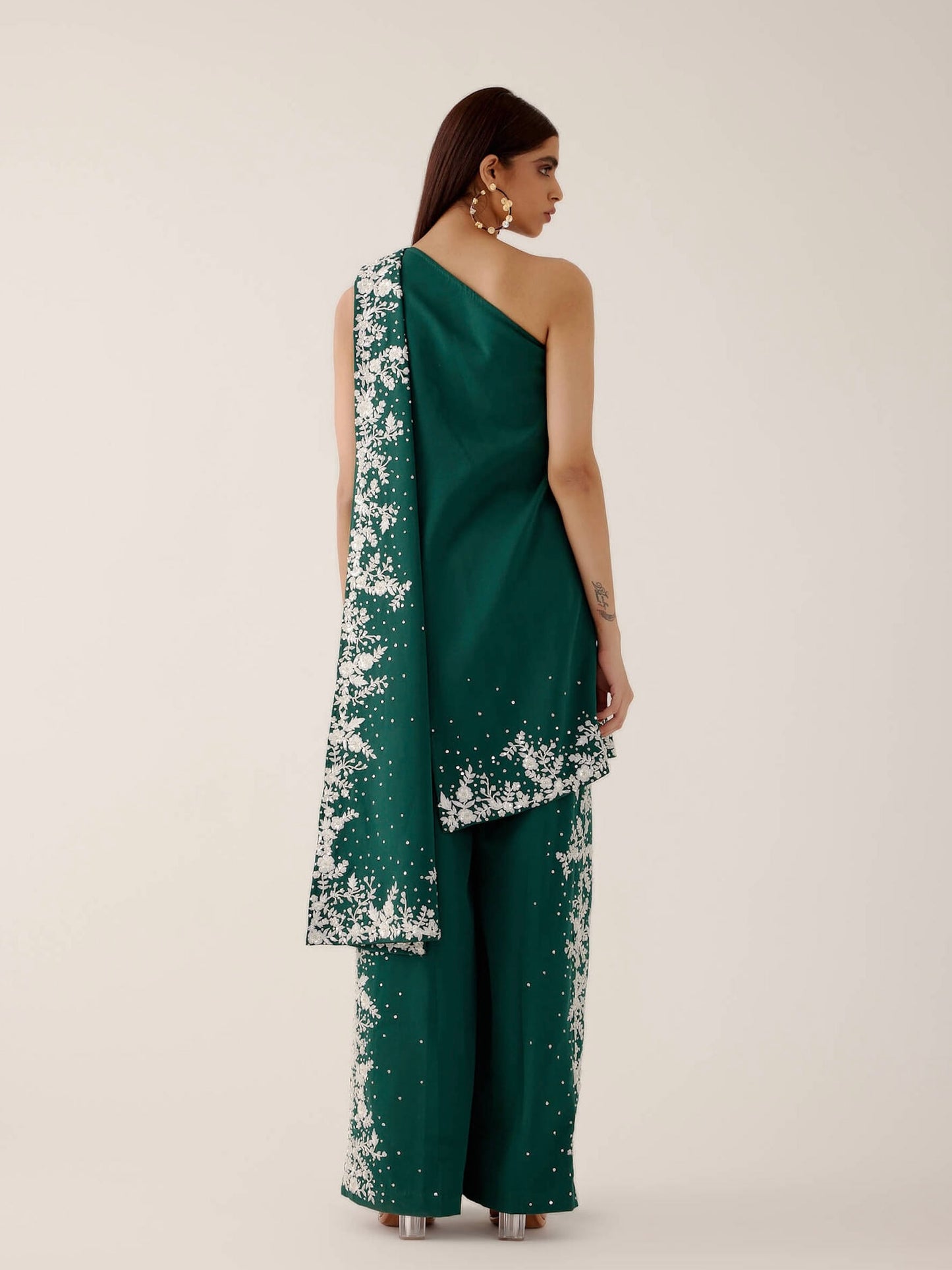 The Cleo Set consists of one shoulder top with hand-embroidered, high-waisted pants, and a detachable drape.