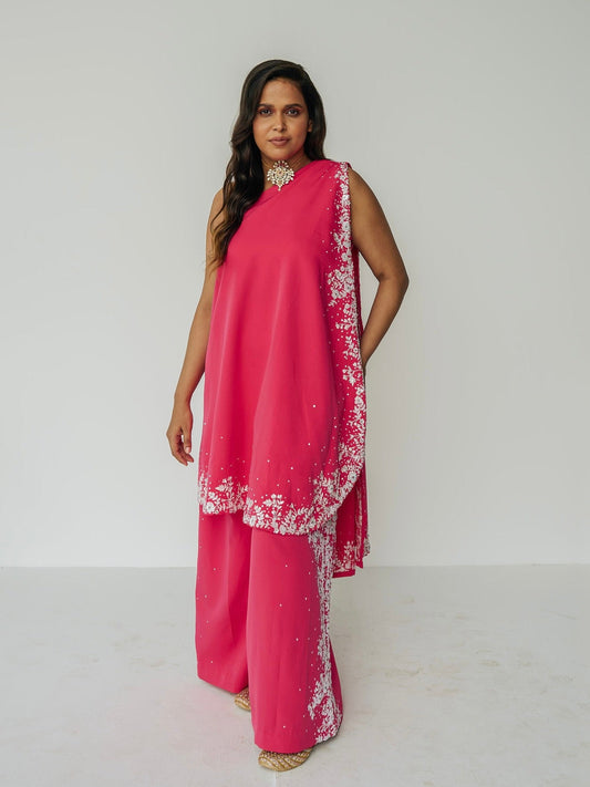 The Cleo Set consists of one shoulder top with hand-embroidered, high-waisted pants, and a detachable drape.
