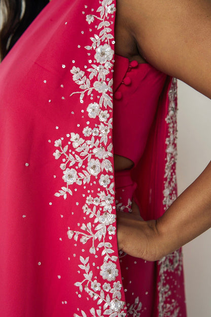 The Cleo Set consists of one shoulder top with hand-embroidered, high-waisted pants, and a detachable drape.