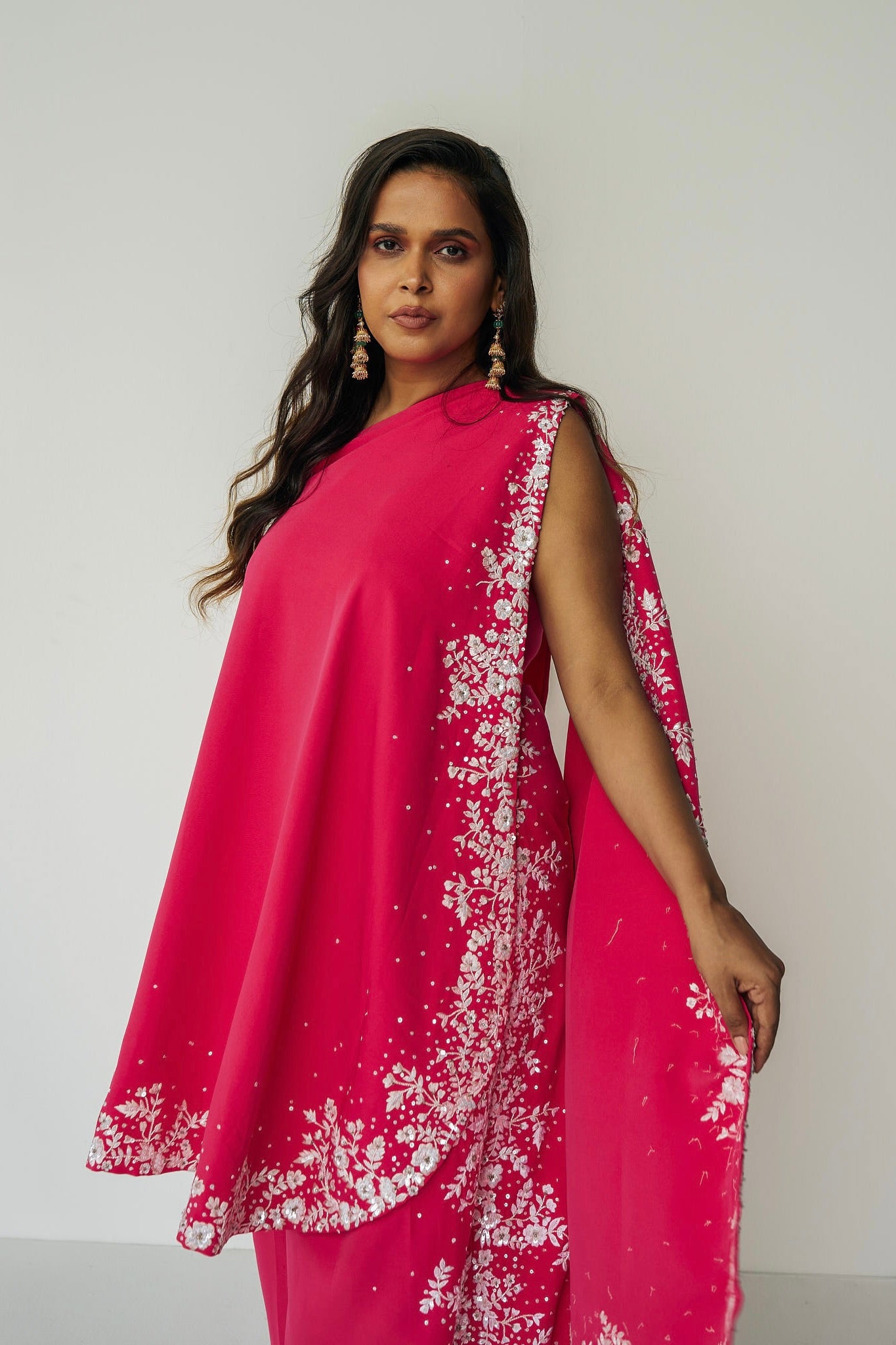 The Cleo Set consists of one shoulder top with hand-embroidered, high-waisted pants, and a detachable drape.