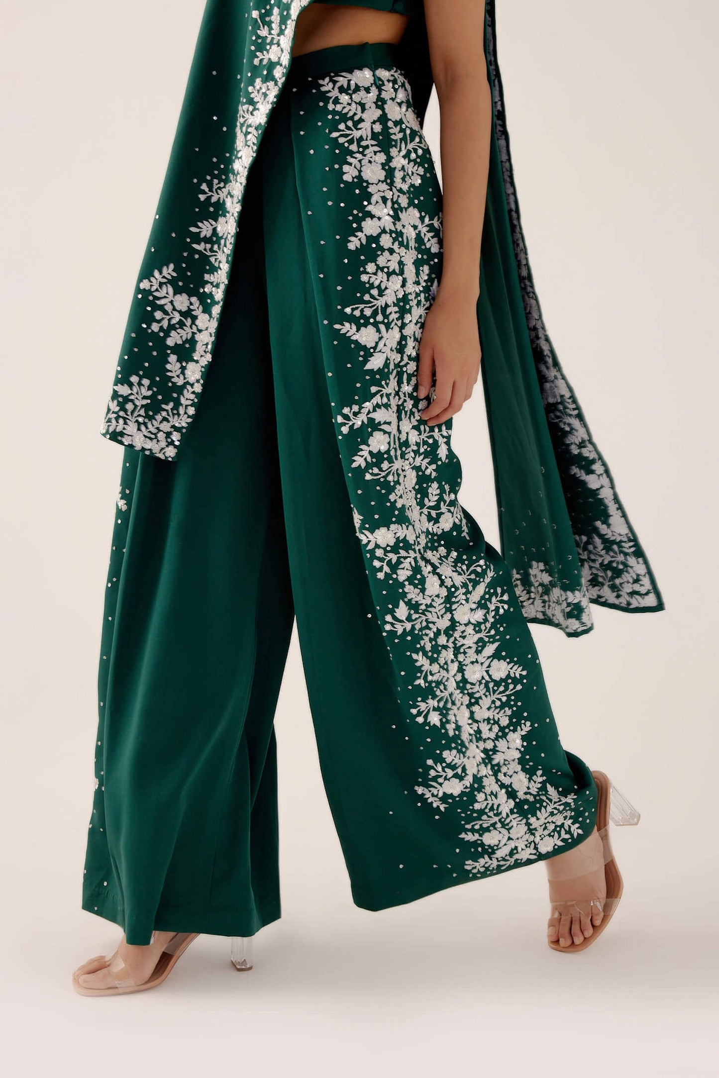 The Cleo Set consists of one shoulder top with hand-embroidered, high-waisted pants, and a detachable drape.