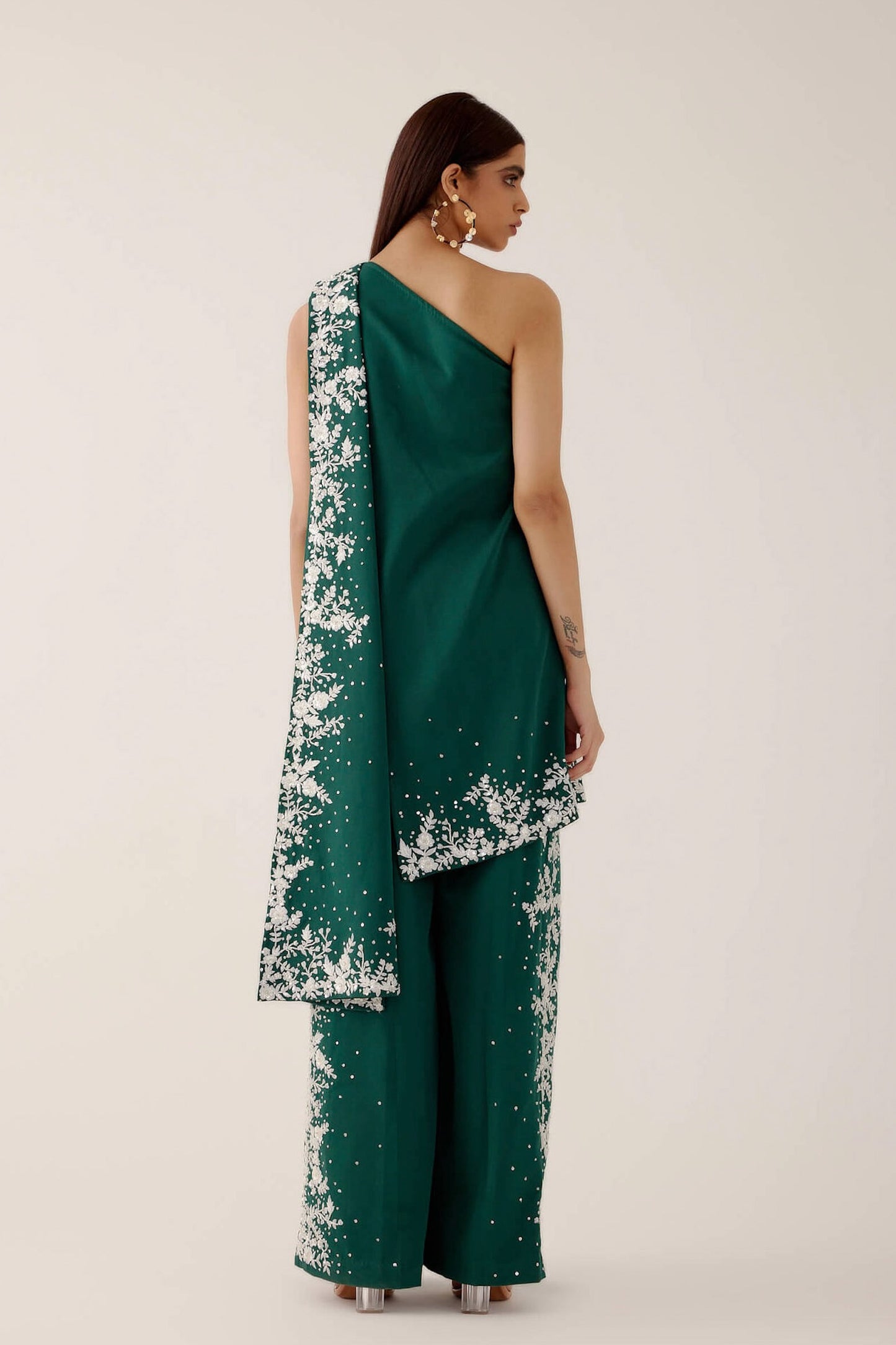 The Cleo Set consists of one shoulder top with hand-embroidered, high-waisted pants, and a detachable drape.
