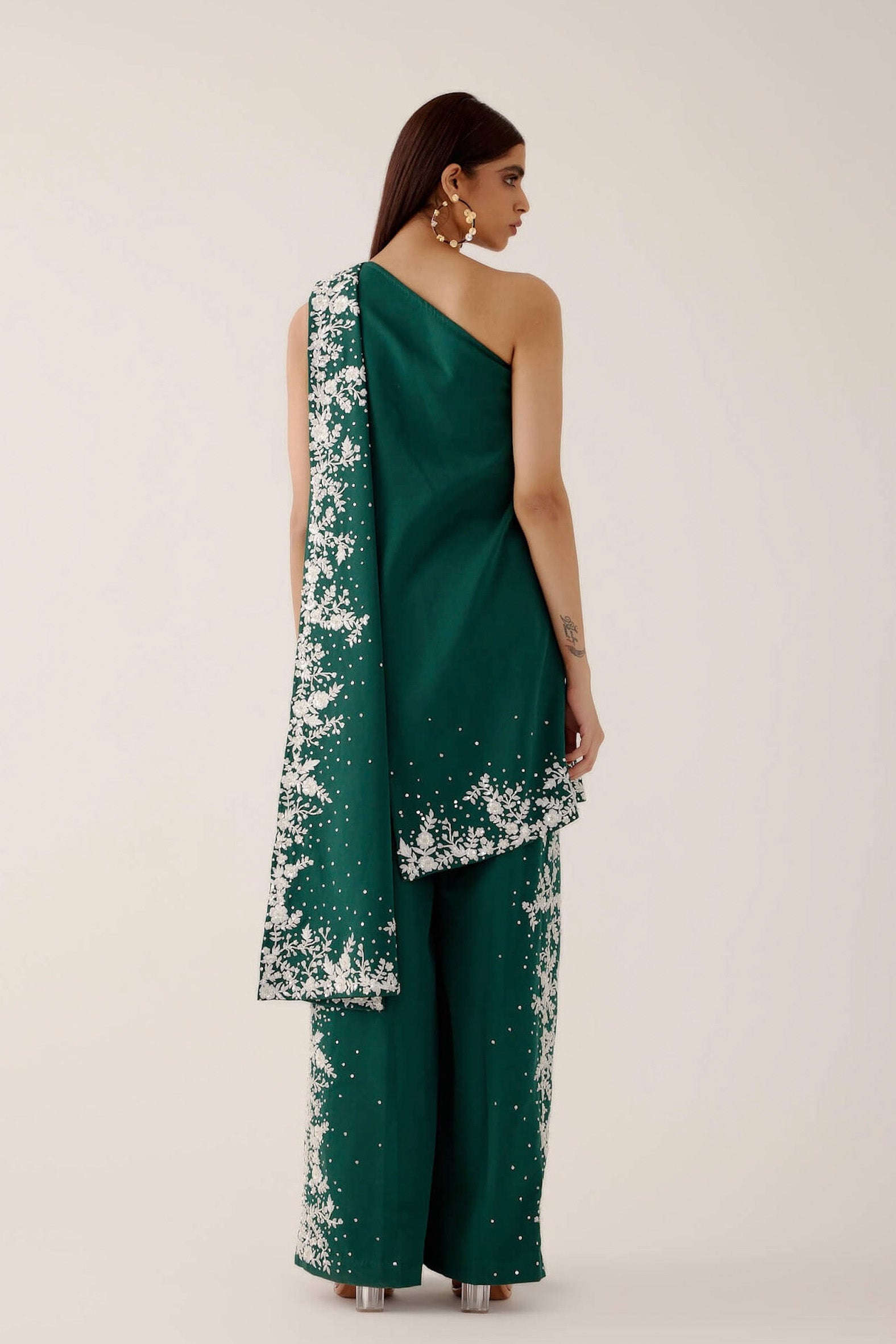 The Cleo Set consists of one shoulder top with hand-embroidered, high-waisted pants, and a detachable drape.