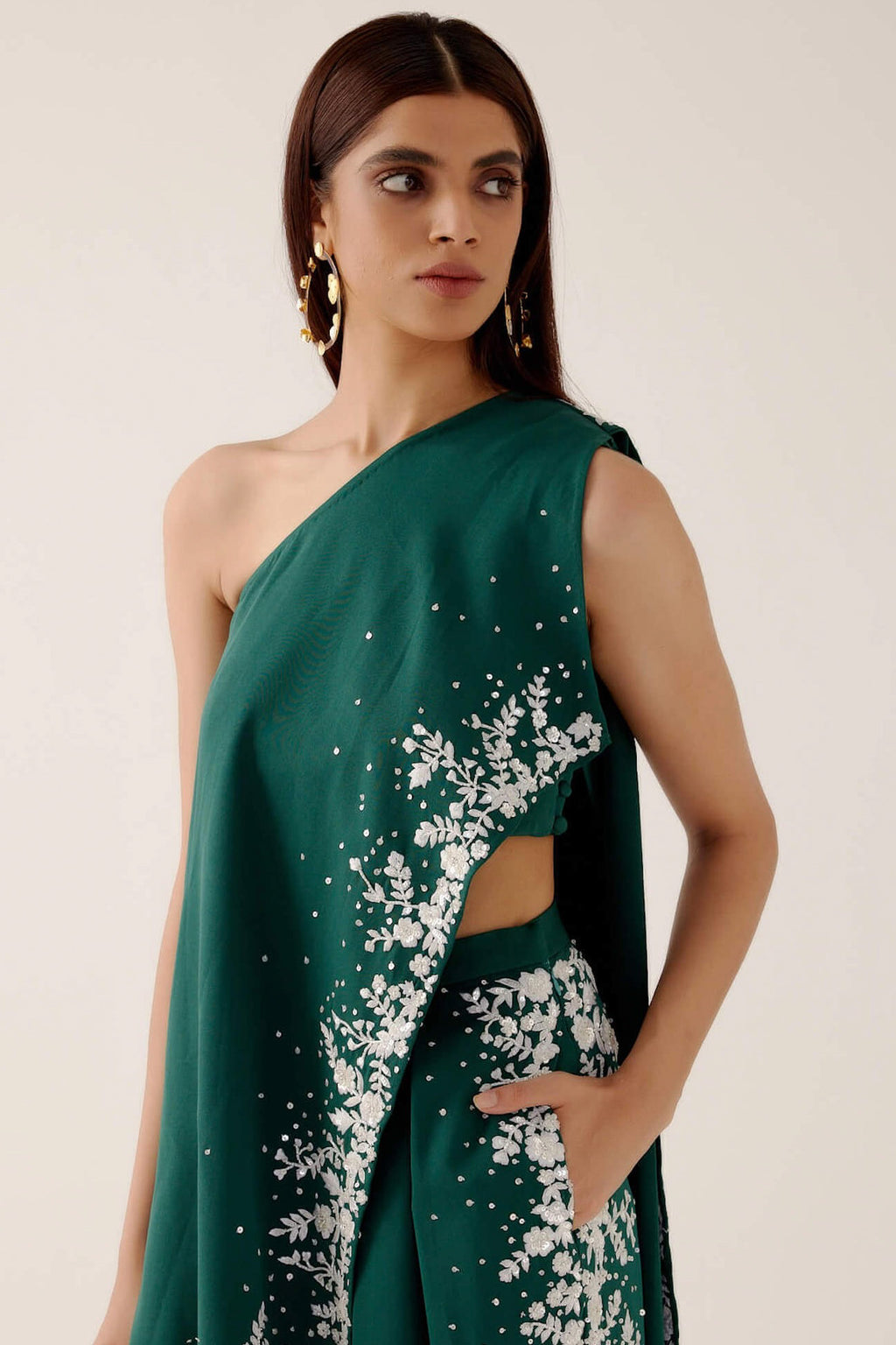 The Cleo Set consists of one shoulder top with hand-embroidered, high-waisted pants, and a detachable drape.