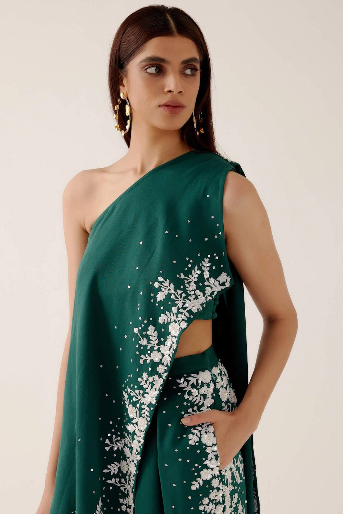 The Cleo Set consists of one shoulder top with hand-embroidered, high-waisted pants, and a detachable drape.