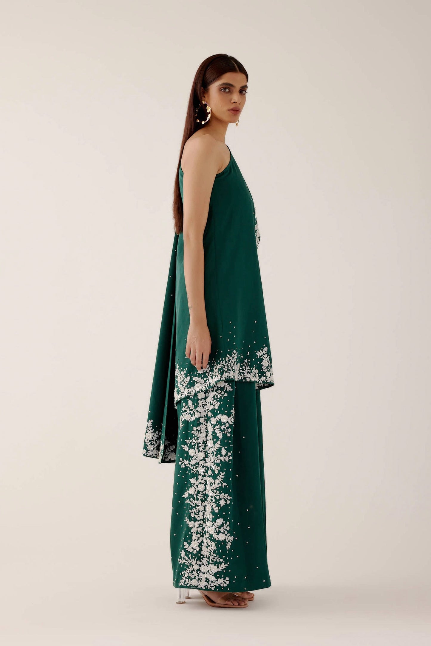 The Cleo Set consists of one shoulder top with hand-embroidered, high-waisted pants, and a detachable drape.
