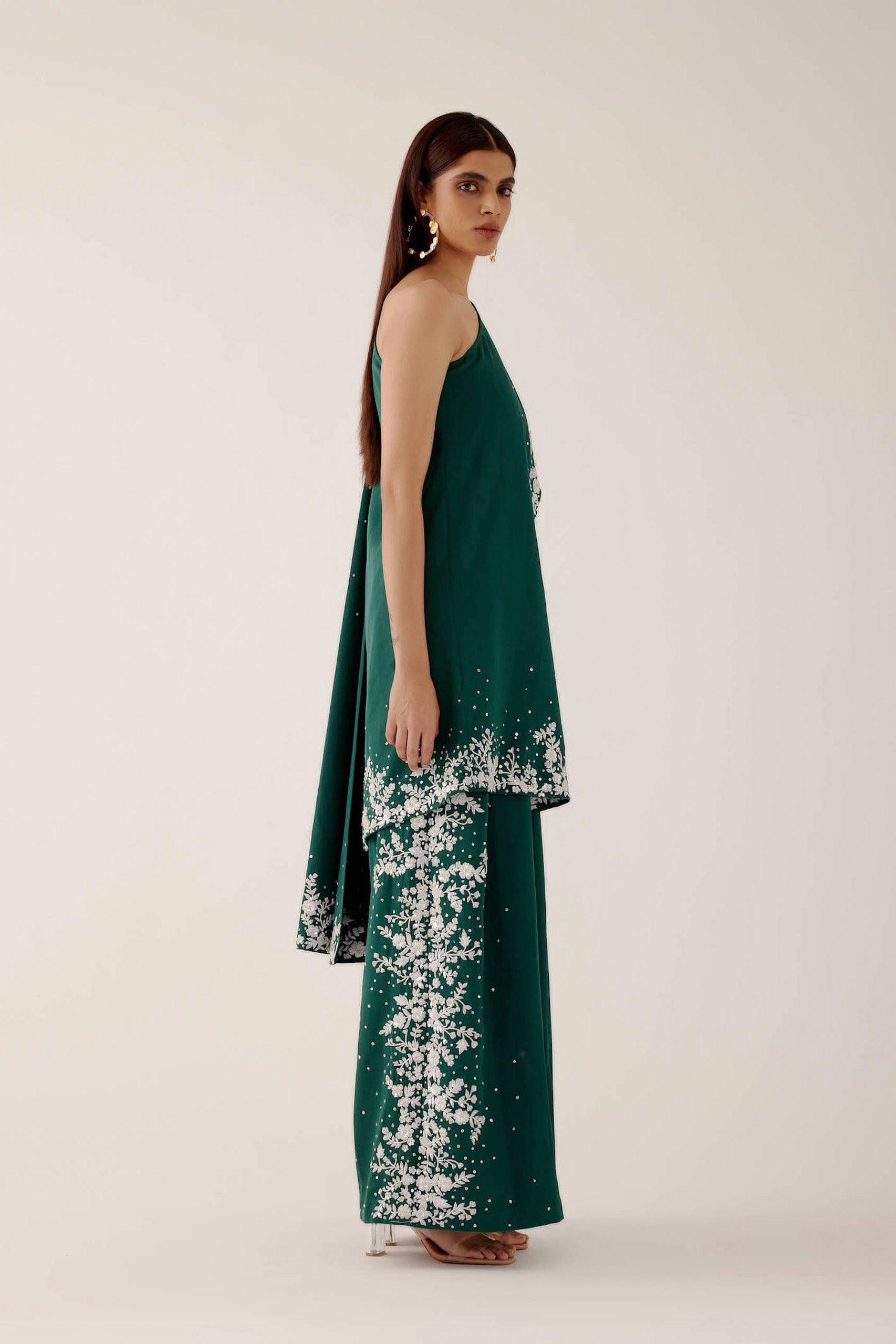 The Cleo Set consists of one shoulder top with hand-embroidered, high-waisted pants, and a detachable drape.