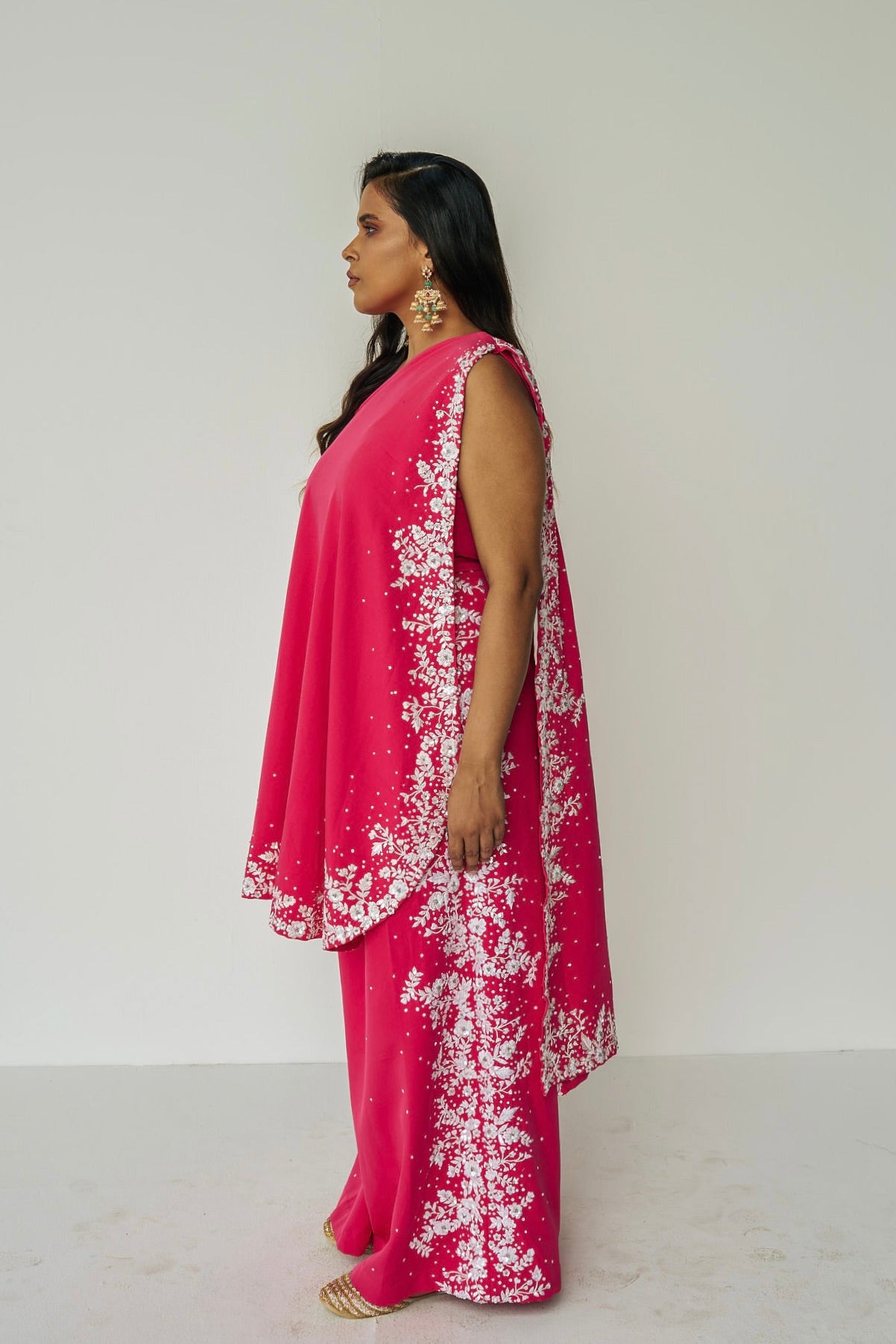 The Cleo Set consists of one shoulder top with hand-embroidered, high-waisted pants, and a detachable drape.
